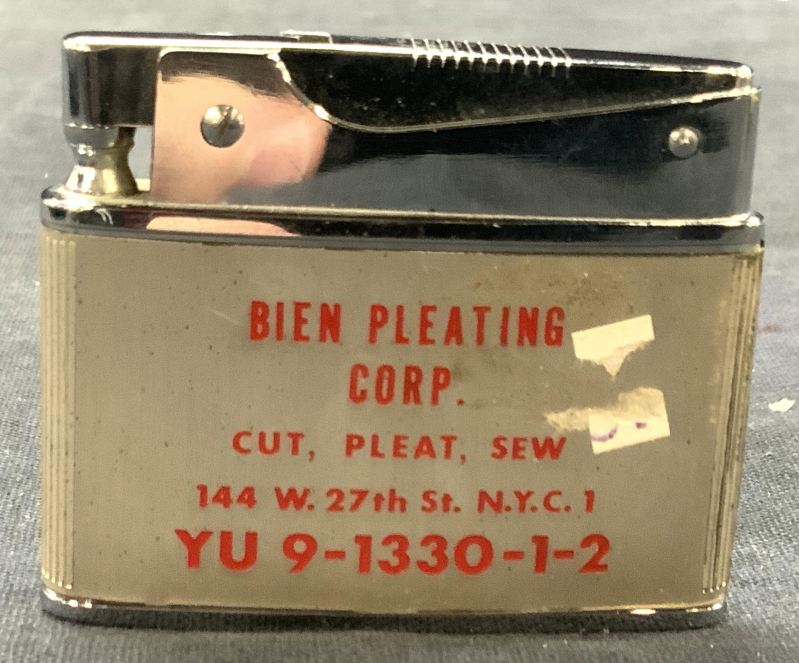 Vintage Metal Bien Pleating Crop Lighter: Vintage butane and wick lighter, marked on side Birn Pleating Corp. marked on underside Japan. Approximately 1.75 x 2 inches. Minor wearing to lighter due to vintage age and use. Vintage lighter, ligh
