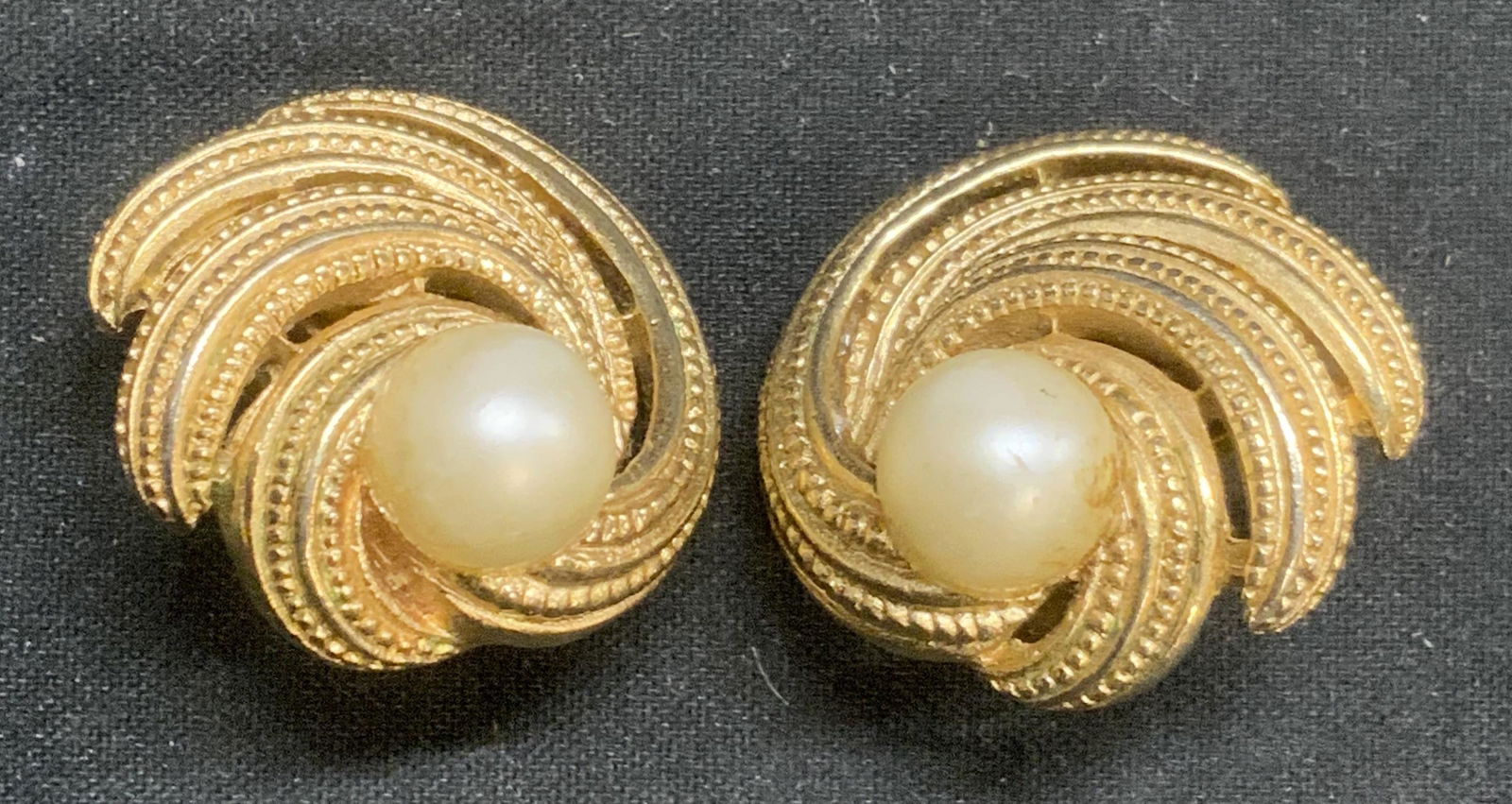 TRIFARI Vtg Gold Tone Faux Pearl Earrings: Vintage Trifari gold tone clip on earrings with faux pearl cabochons. Designer label to backing. Some surface wear consistent with exposure. Measure approx. 7/8 inches diameter. Estate jewelry, costum