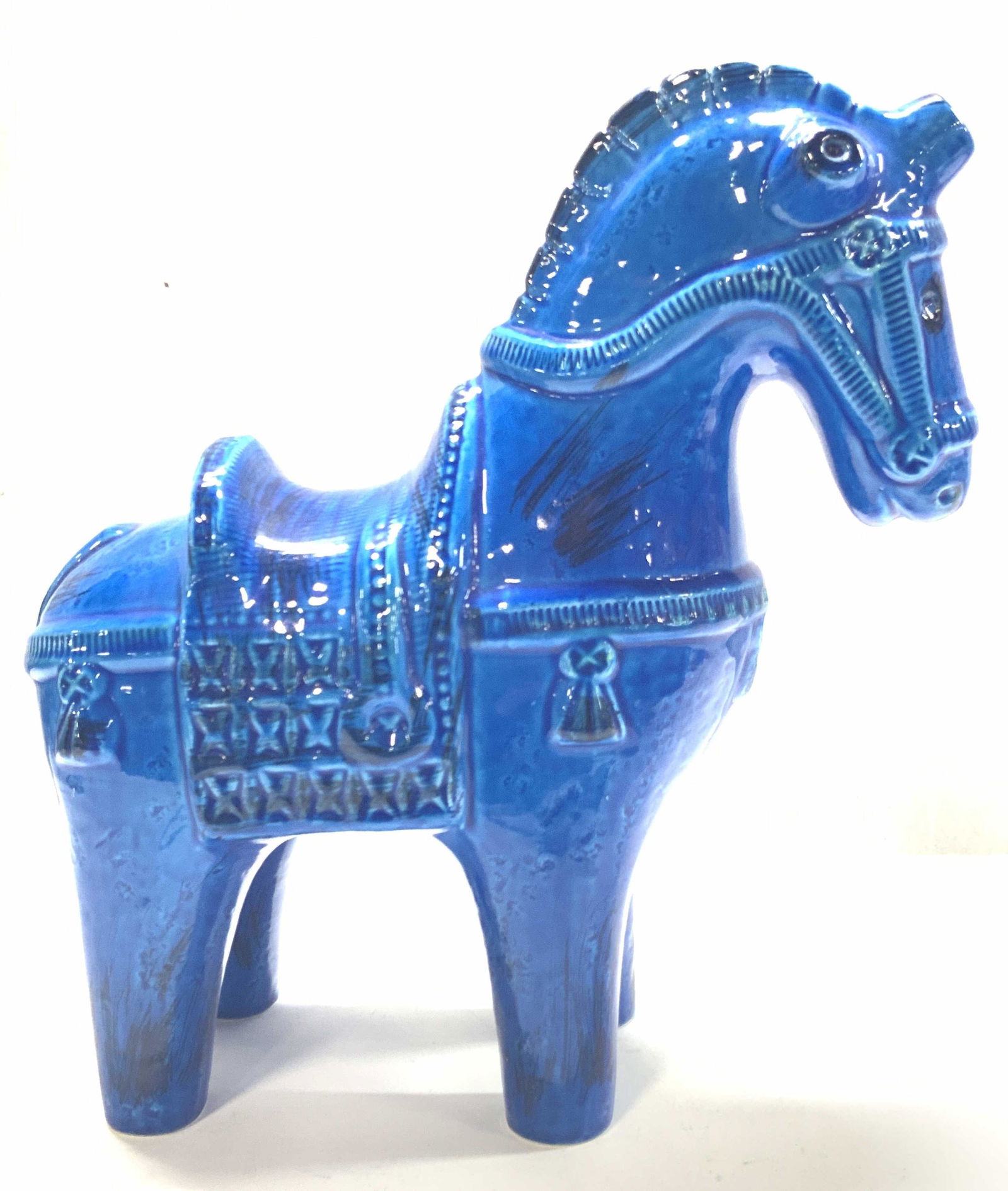 BITOSSI Ceramic Blue Glazed Horse Sculpture, Italy: Marked on undersides BITOSSI, Made in Italy. Blue glazed Trojan horse with saddle and reins. Approximately 12.25 inches tall and 12 inches long. Evident crazing to ceramic surface. Property of Palm Be