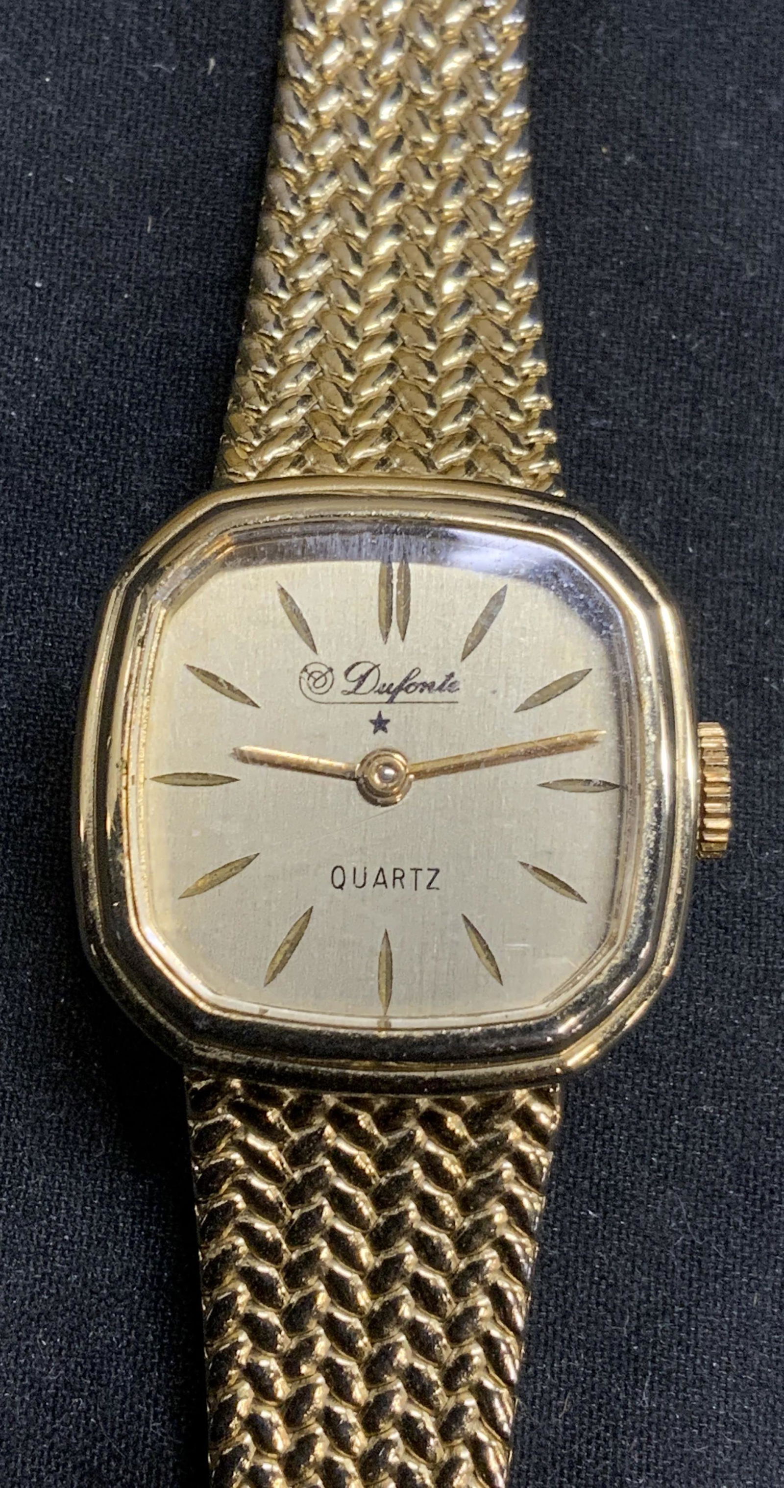 DUFONTE Gold Tone Wristwatch, Italy: DUFONTE gold tone mesh band wristwatch. Marked Italy on clasp. In good condition. Measures approx. 7.75 inches long. Not tested for function. Stainless steel back. Serial number 96102209. Includes Ros