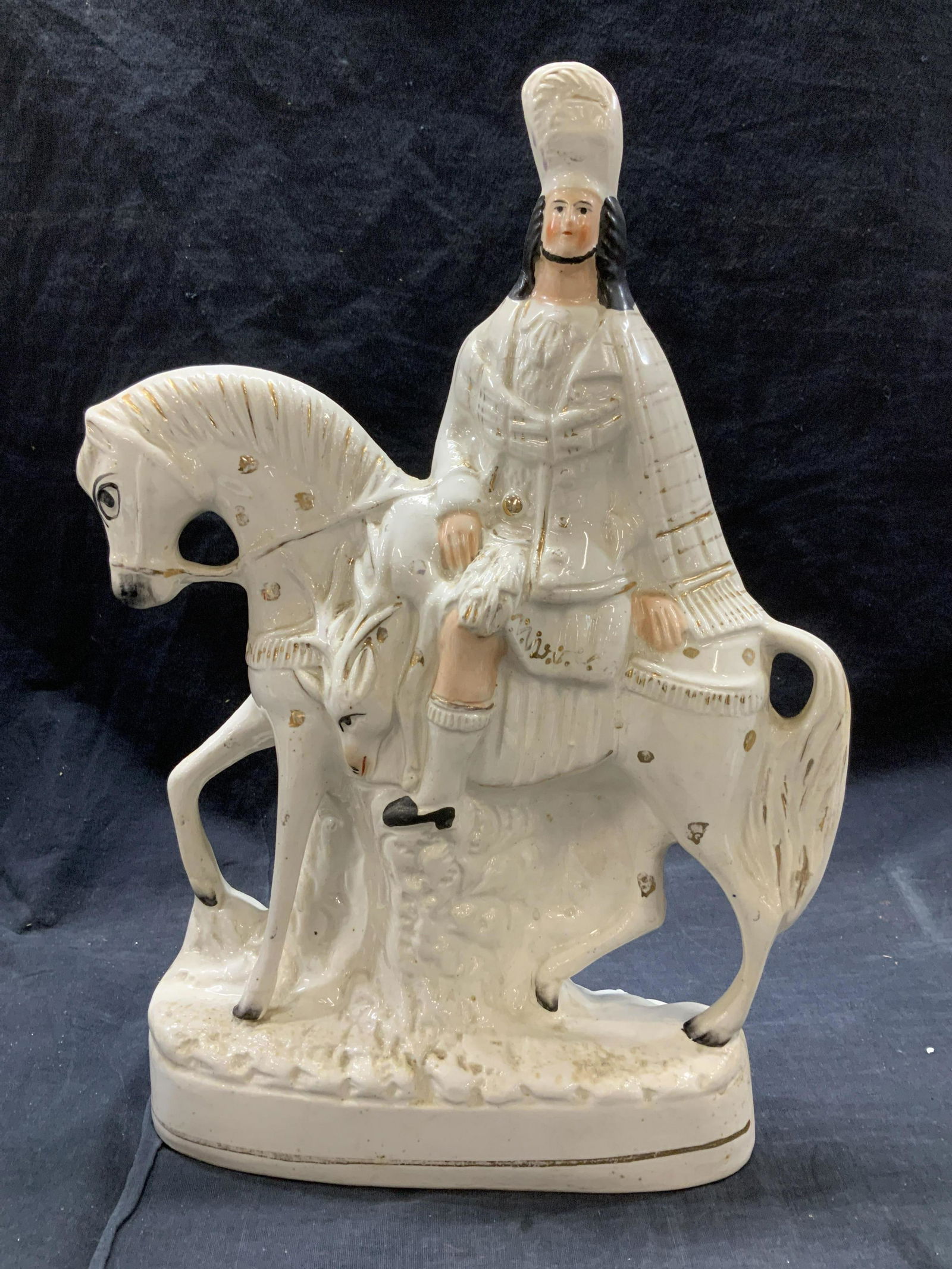 STAFFORDSHIRE Cavalier Scots Porc Figural England: Antique Staffordshire , Circa 1860, all white glazed porcelain statue with Scottish rider/ hunter on horse, a stag draped over the horse. Areas of gilt. Made in England. Hand painted A John J. Gredler