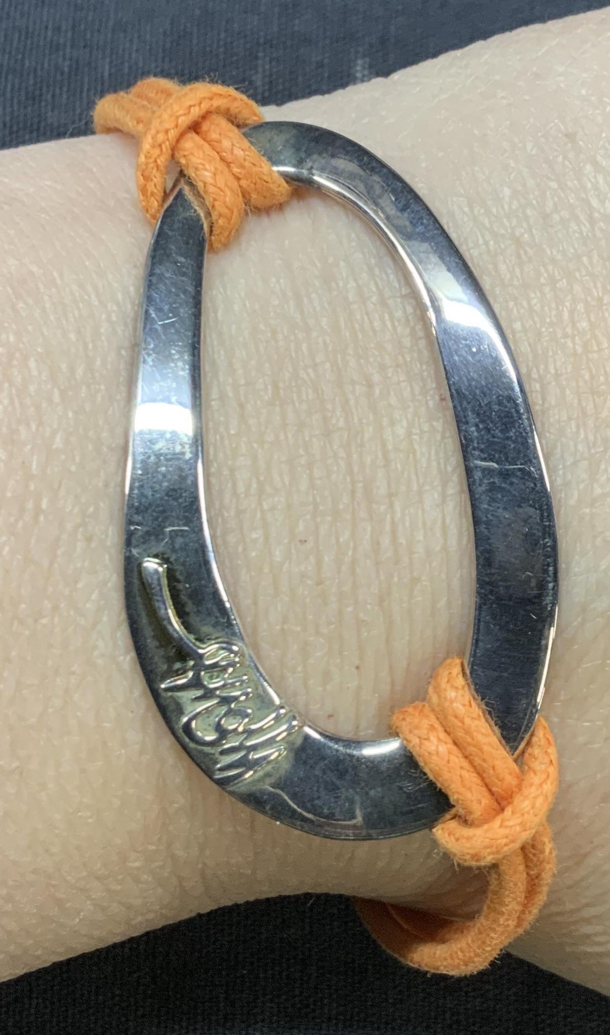 IPPOLITA STERLING SILVER CORD BRACELET Pouch ITALY: Ippolita Sterling Silver 925 Orange Cord Bracelet. Signed Ippolita on sculptural Oval shape that is center focus of the bracelet. Signed Ippolita and 925 on clasp. 7-7.5 in long. Sculptural piece meas