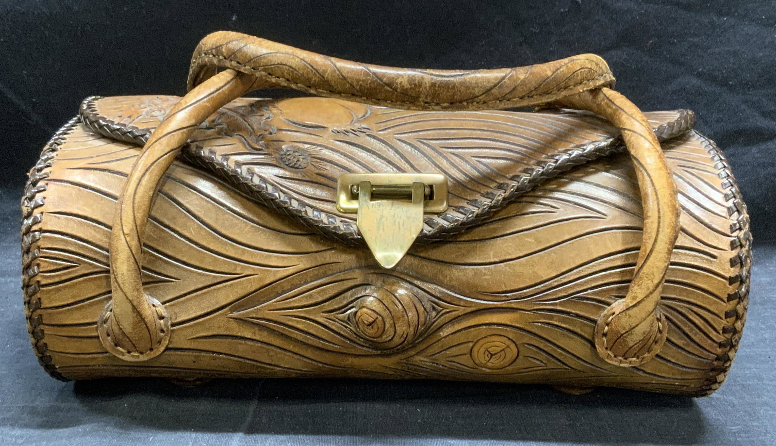 Artisan Crafted Leather Log & Squirrel Handbag: Artisan crafted brown leather handbag. Hand tooled leather. Log form with squirrel motif. Fold over flap, 1 zippered pocket and 2 slip pockets to interior, no labels to piece. Wear to leather consiste