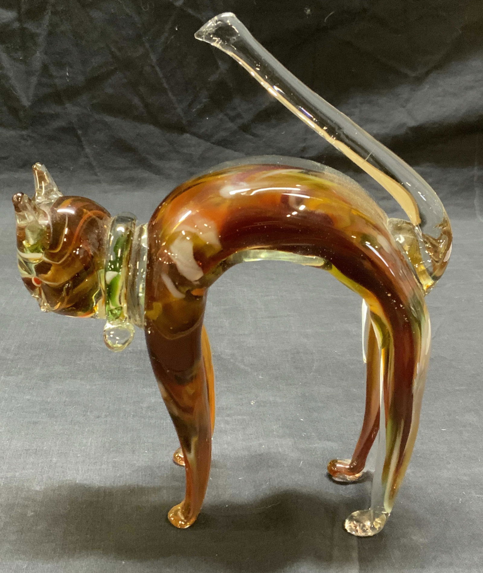Arching Cat Hand Blown Art Glass Figurine: Hand blown art glass figurine of a cat with arched back. Hues of amber, brown, and white. Measures approx. 6 x 2 x 7.25 inches. In good condition. Art glass, Studio glass, cat figurine, art glass cat,