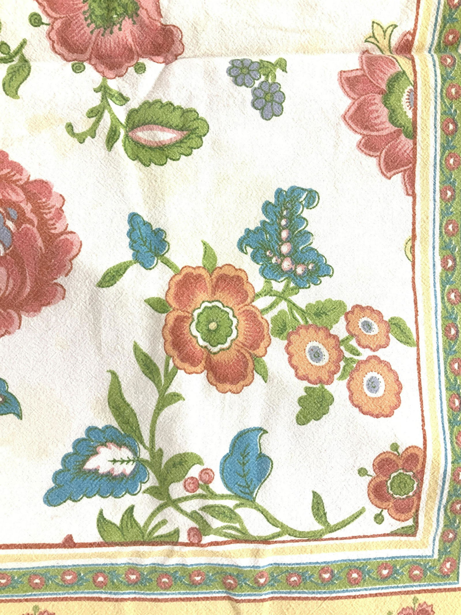 French Country Floral Cotton Tablecloth: Cotton tablecloth with colorful French country style florals on white background, lime green and yellow border with florals. Measures 60 x 53 in. Has blemishing consistent with use. Up cycle textiles.