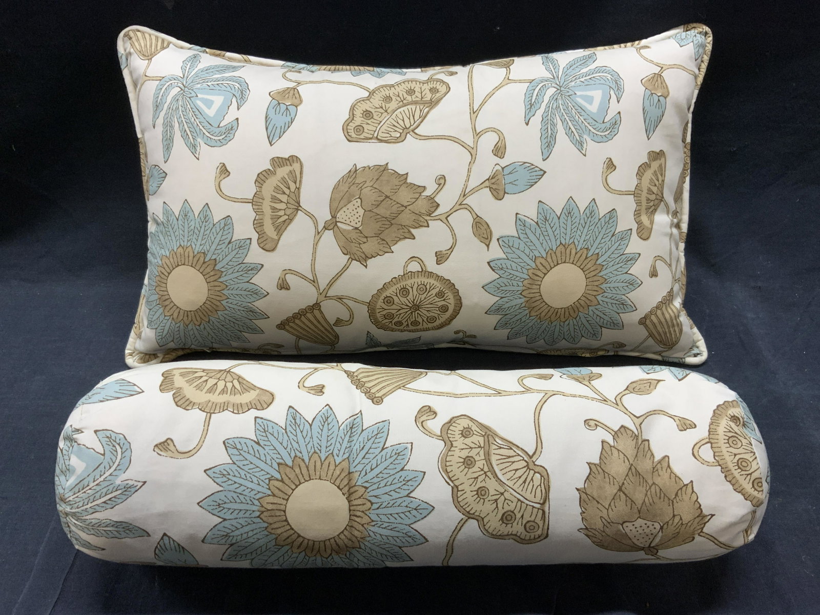 Lot 2 Banquette & Bolster Pillow: Lot includes 1 bolster & 1 banquette pillow. Each have multi toned floral, vine, & leaf detail. Banquette pillow has welting at edges. Measures approx 18.25 inches long 10.5 inches wide. Pillow, flora
