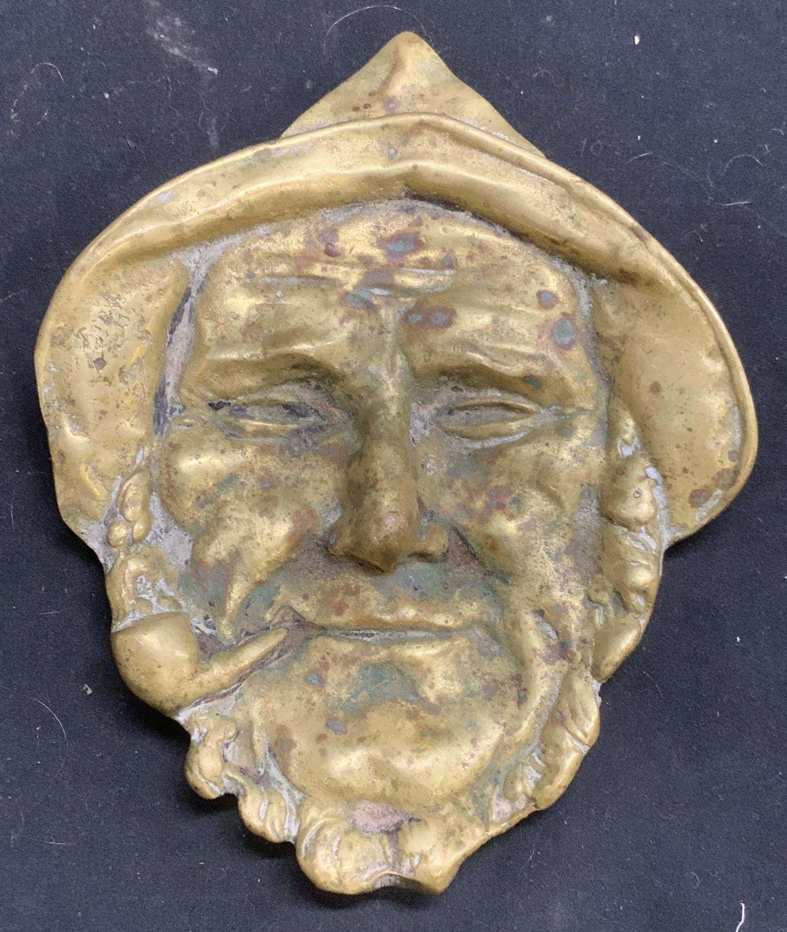Vintage Brass Figural Table Accessory: Vintage brass figural form table accessory. Figure of man smoking pipe. Surface wear consistent with exposure. Measures approx. 5 x 6.25 inches. Brass dish, brass table accessories, figural dish, figu
