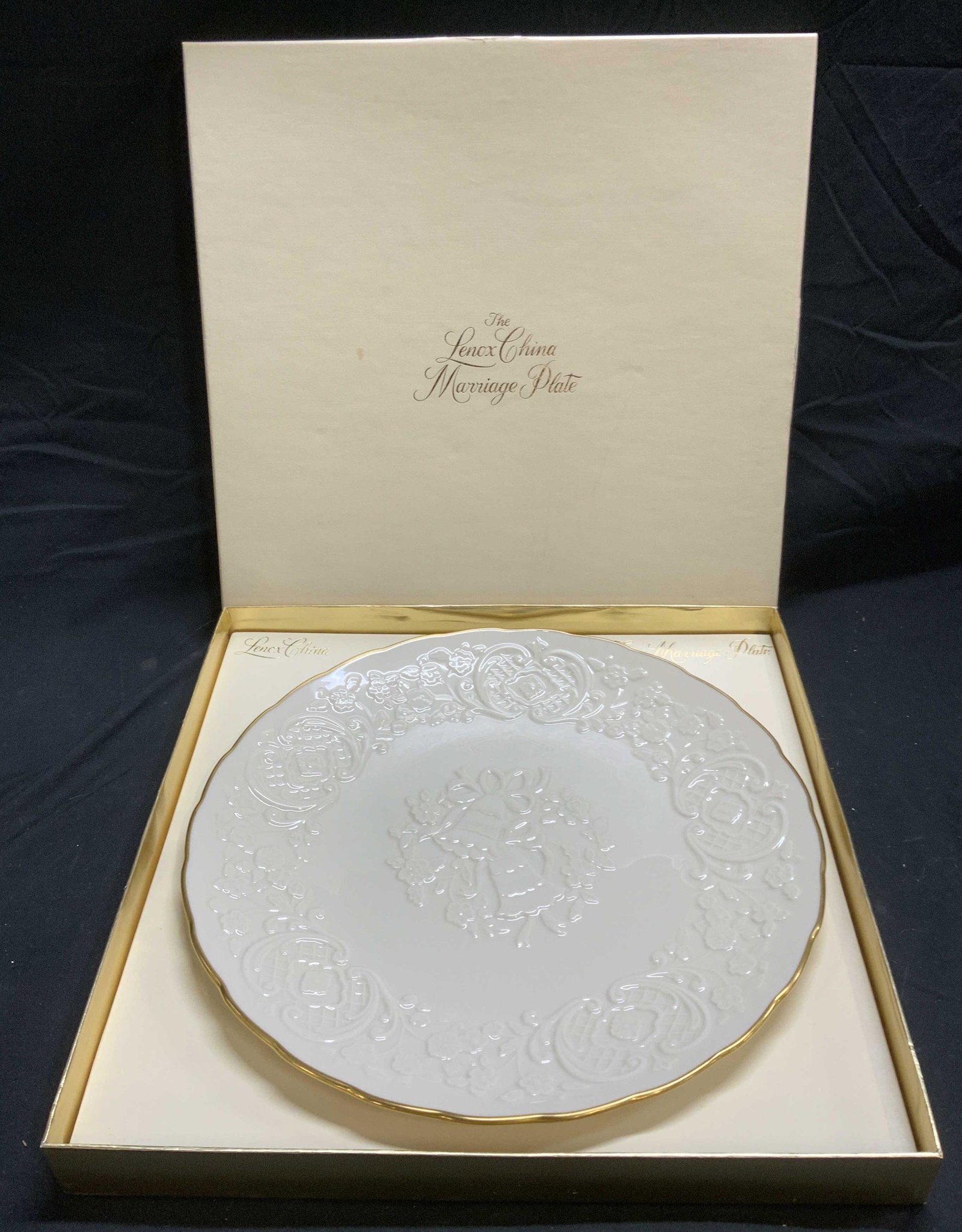 LENOX China Marriage Plate in Box: Lenox Chinaware Marriage Plate in original box. Like New condition. Trademarked to underside. Plate embossed with wedding bell and scroll motif. Measures approx. 12.5 inches diameter. Box measures app