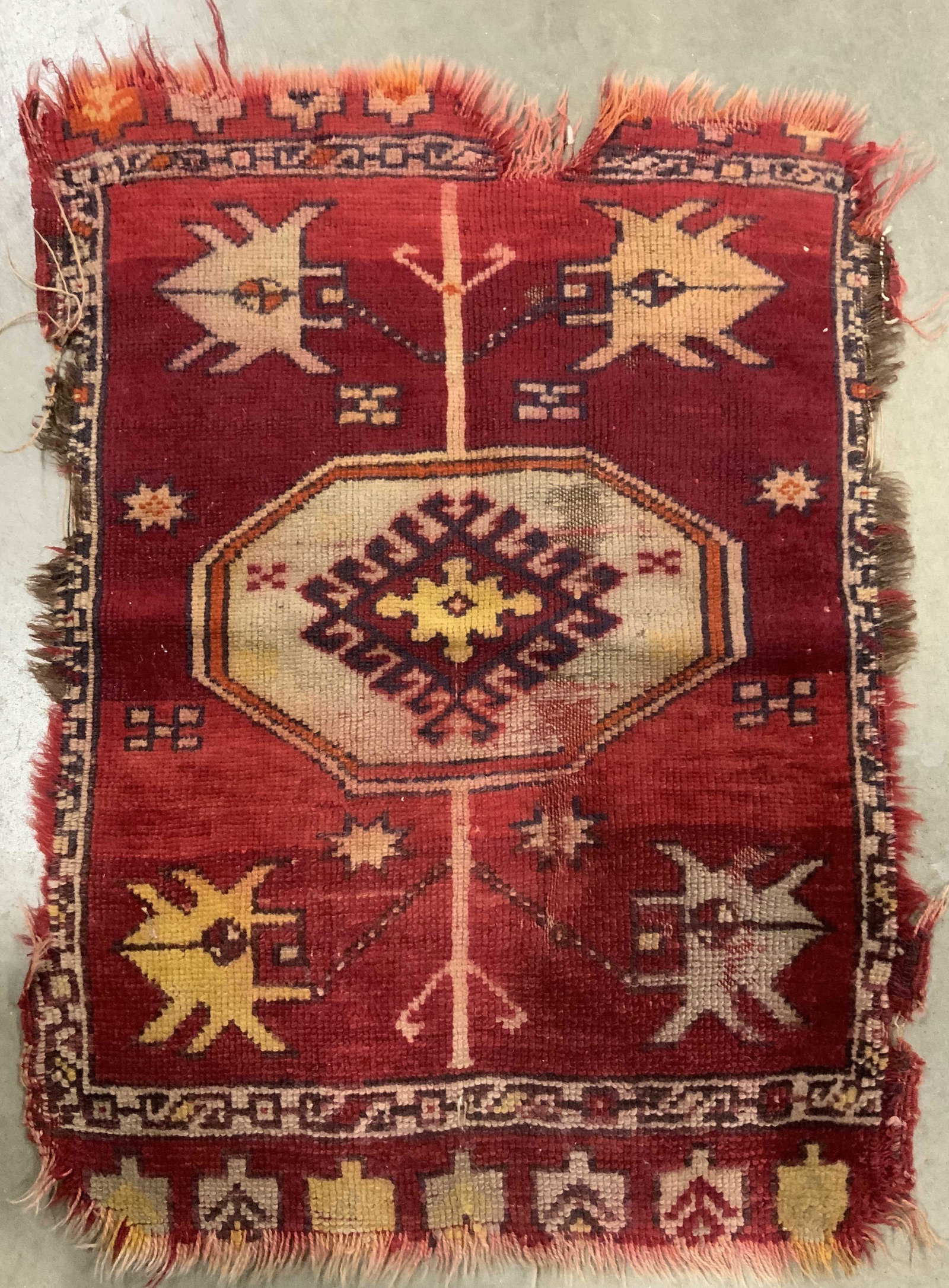 Antique Handmade Turkish Wool Area Rug: Rug is handmade and wool. Piece has intricate multi toned geometric detail. Rug appears to be Turkish. Measures approx 28 inches long 21 inches wide. Rug has brown toned fringes at edges. Rug, wool ru