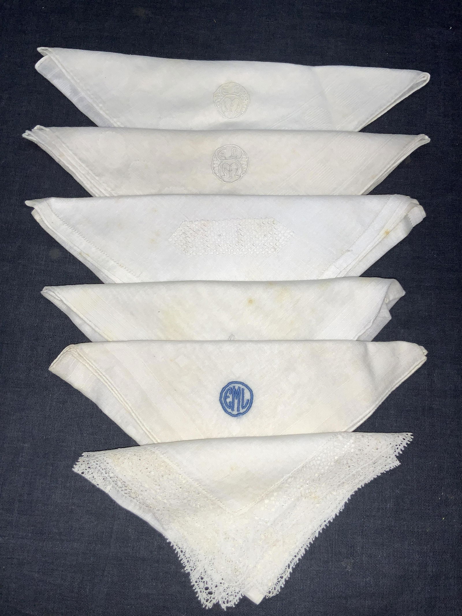 Lot 6 Vintage Starch Embroidered Handkerchiefs: Lot of 6 starch Embroidered handkerchiefs. 2 with boarders of cross hatching designs with embroidered EML on corners. Approx 11 x 11 inches. 1 with blue embroidered EML in circle on corner 1 with embr