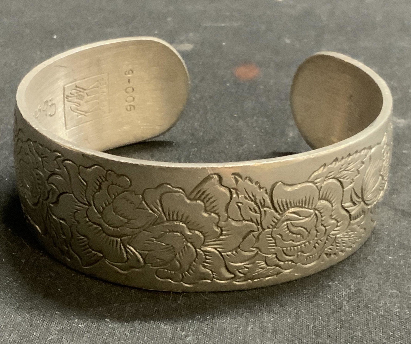 Vtg KIRK Etched Floral Pewter Cuff Bracelet: KIRK Etched floral motif pewter cuff bracelet. Interior marked pewter. Inscribed with Congratulations message. Dated 1995. Measures approx. 2 3/8 inches wide. Surface wear consistent with exposure. Es