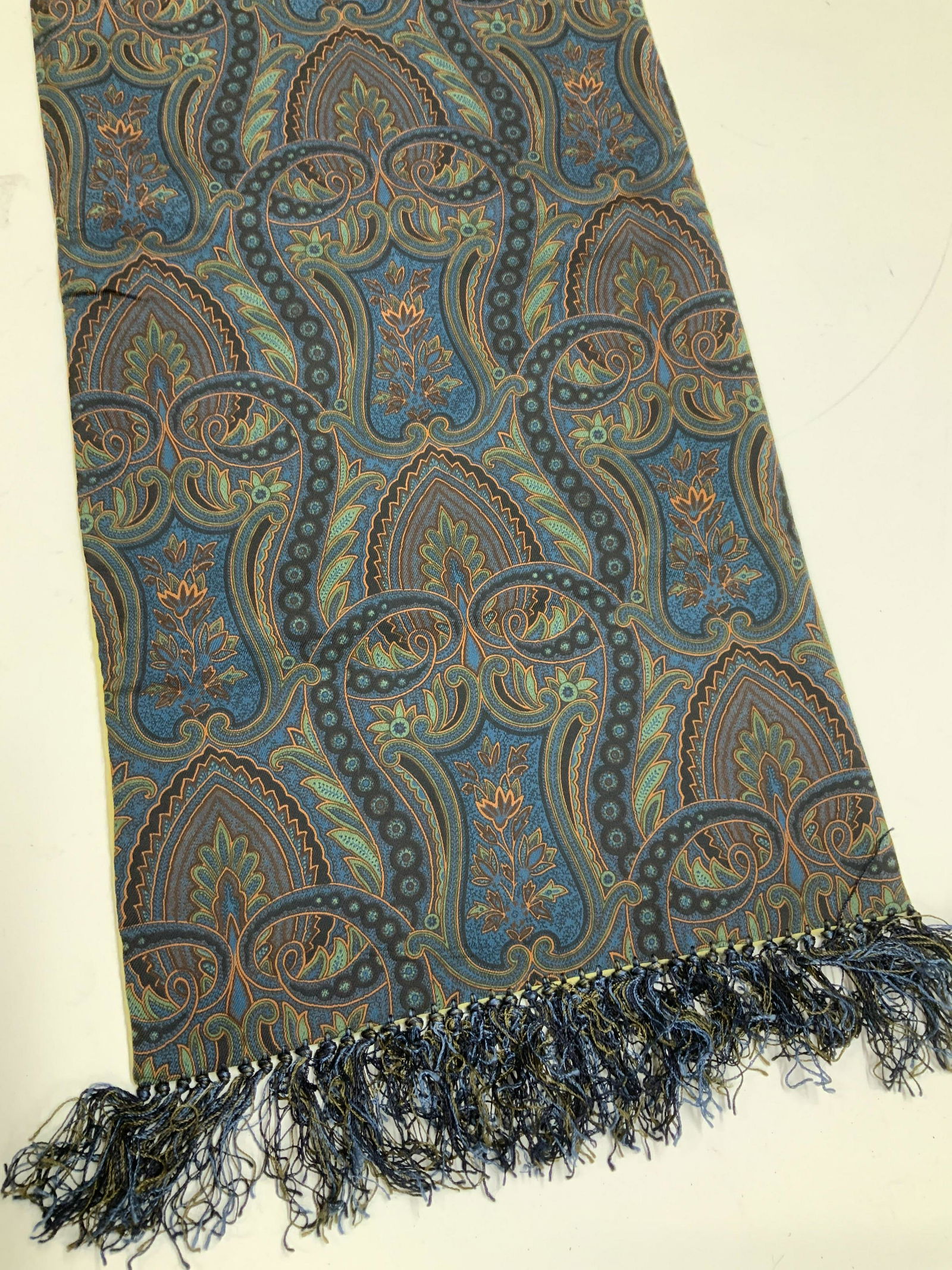 M. Bardelli Silk & Cashmere Paisley Scarf, England: Scroll and paisley Silk Scarf, navy with accents of orange and green. Other side is cashmere. Labeled M Bardelli and Made In England. Measures 11 x 55 in. 1 puncture to cashmere side. Dress Scarf, Sil