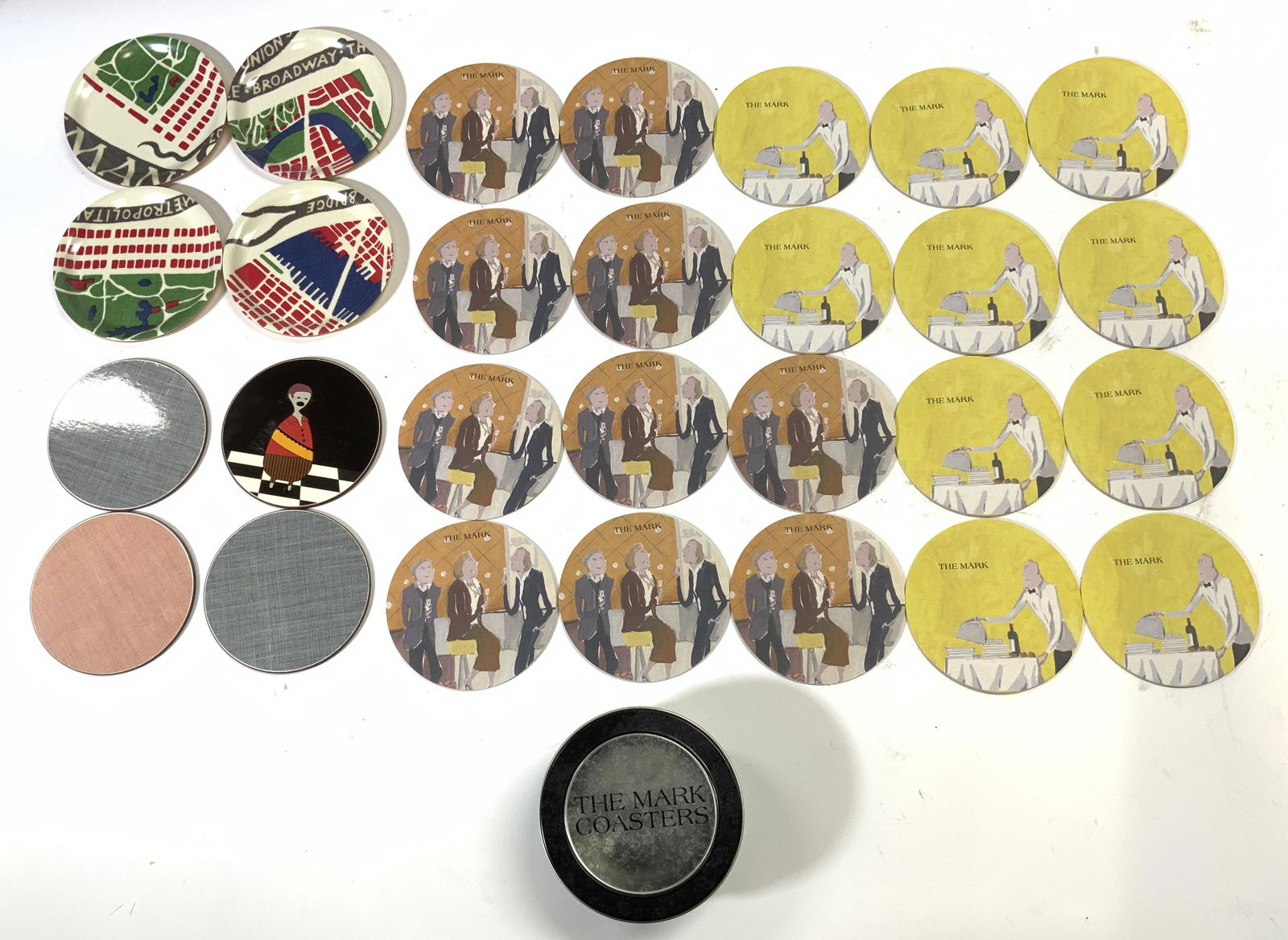 Lot 28 Coasters & Box: Lot includes 20 THE MARK COASTERS, 4 coasters with map images of New York City, 2 grey toned coasters, 1 peach toned, & 1 with image of figure Box measures approx 4.25 inches diameter 2.25 inches tall