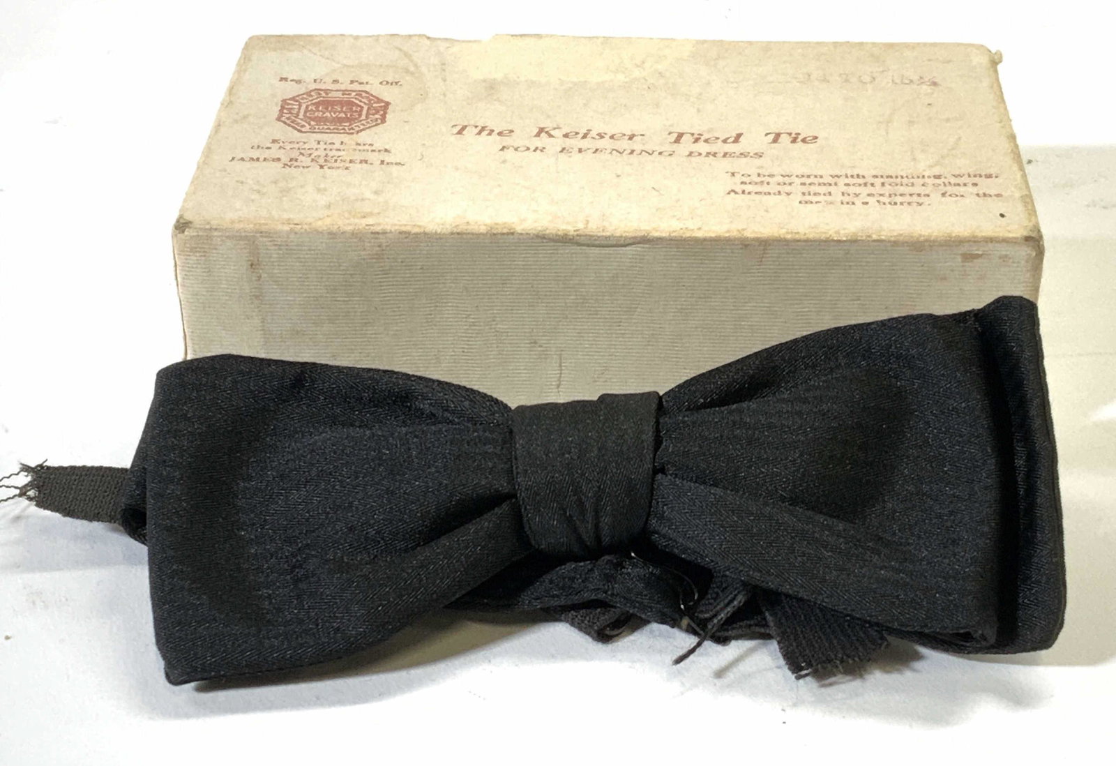 Vtg KEISER CRAVATS The Keiser Tied Tie w Box: Vintage KEISER Cravats The KEISER Tied Tie with original box. Fits neck size 14-15.5. Bow measures approx. 4.5 x 1.75 inches. Strap needs repair. KEISER cravats, KEISER tie, KEISER bow tie, KEISER tie