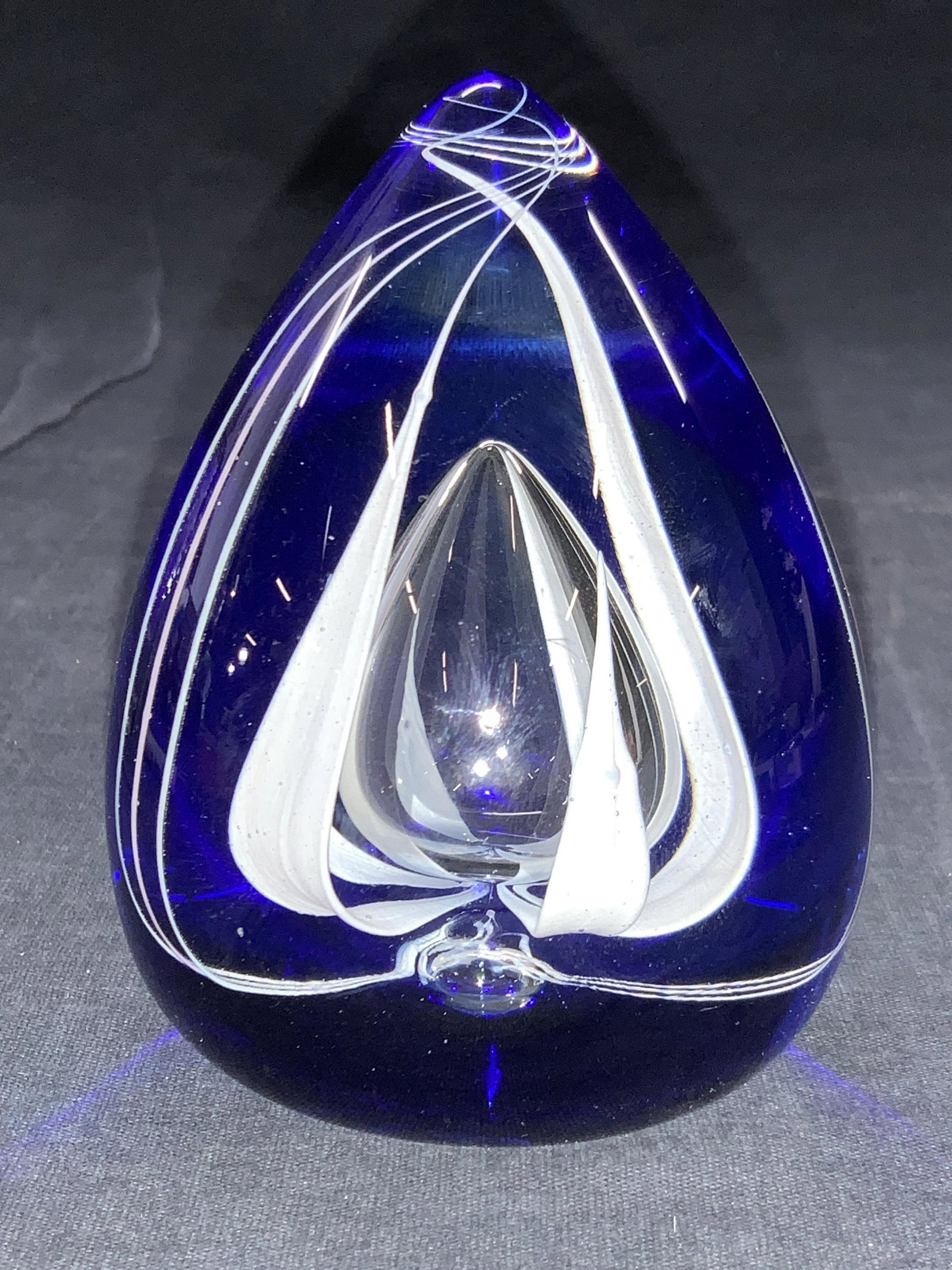 CAITHNESS MOONRISE Teardrop Art Glass Paperweight: Marked on underside Caithness Moonrise Scotland. 13/750. This teardrop shaped paperweight is cobalt blue toned with white floral designs within center of glass. Approximately 4.25 inches tall. Caithne