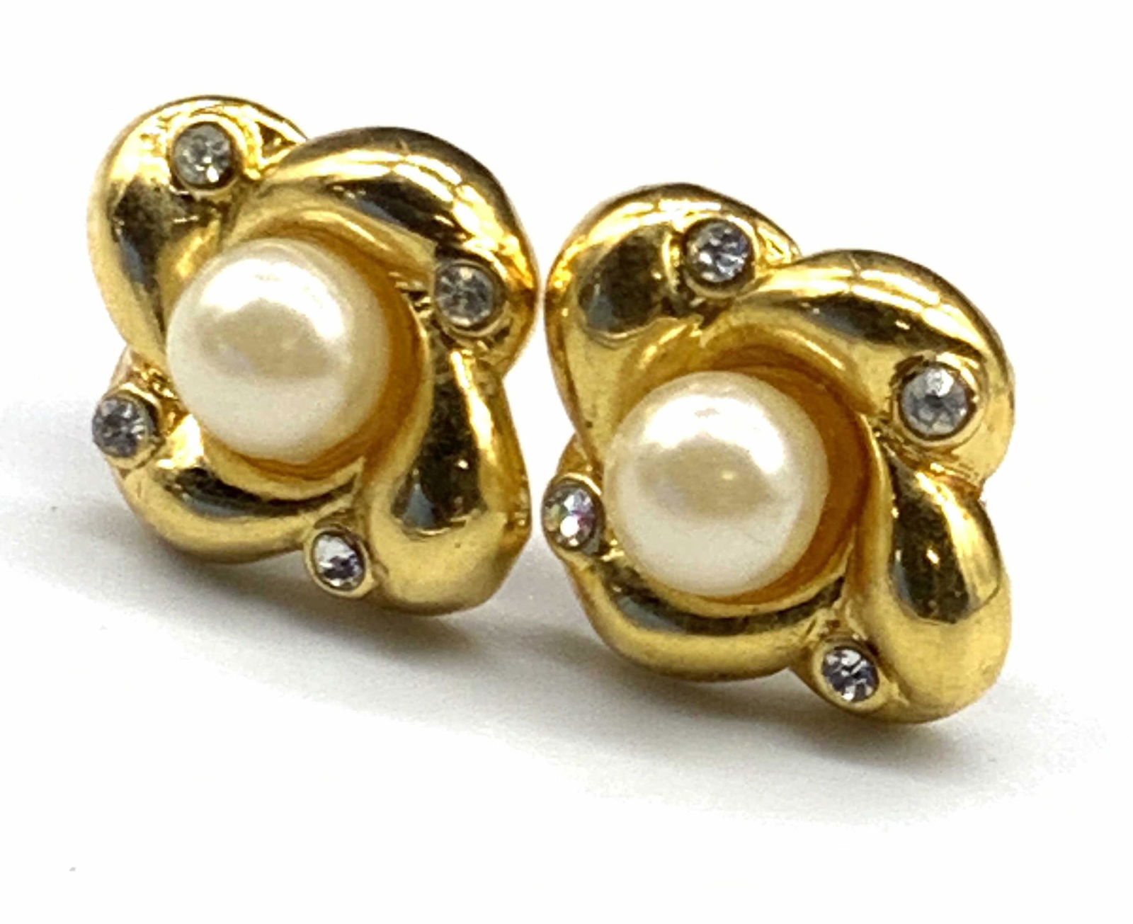 Vintage Pearlescent Floral Form Stud Earrings: Vintage gold tone metal floral form earrings with pearlescent bead centers flanked by faceted crystals. Backings for pierced ears. Measures approx .5L x .5W in. Some surface wear present, some losses