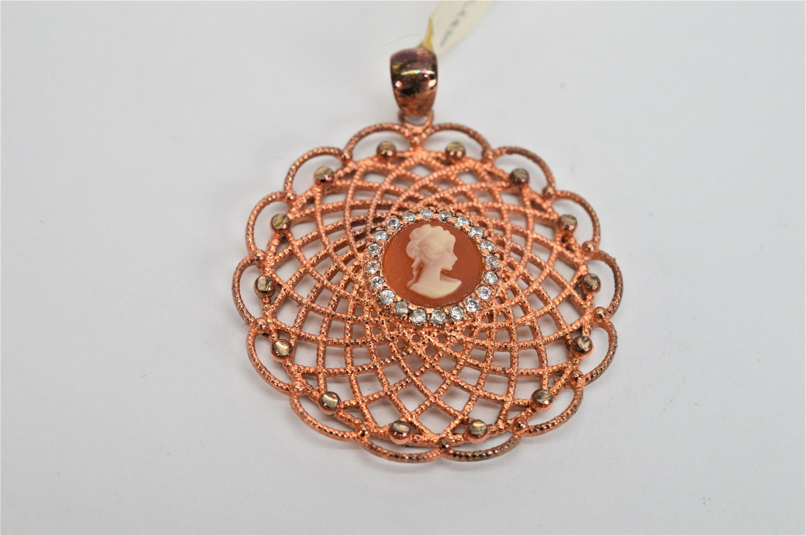 Rose gold plated cameo pendant: Rose gold plated fancy filigree cameo pendant. Made in Italy. Measures 1.75 in diameter. -NB