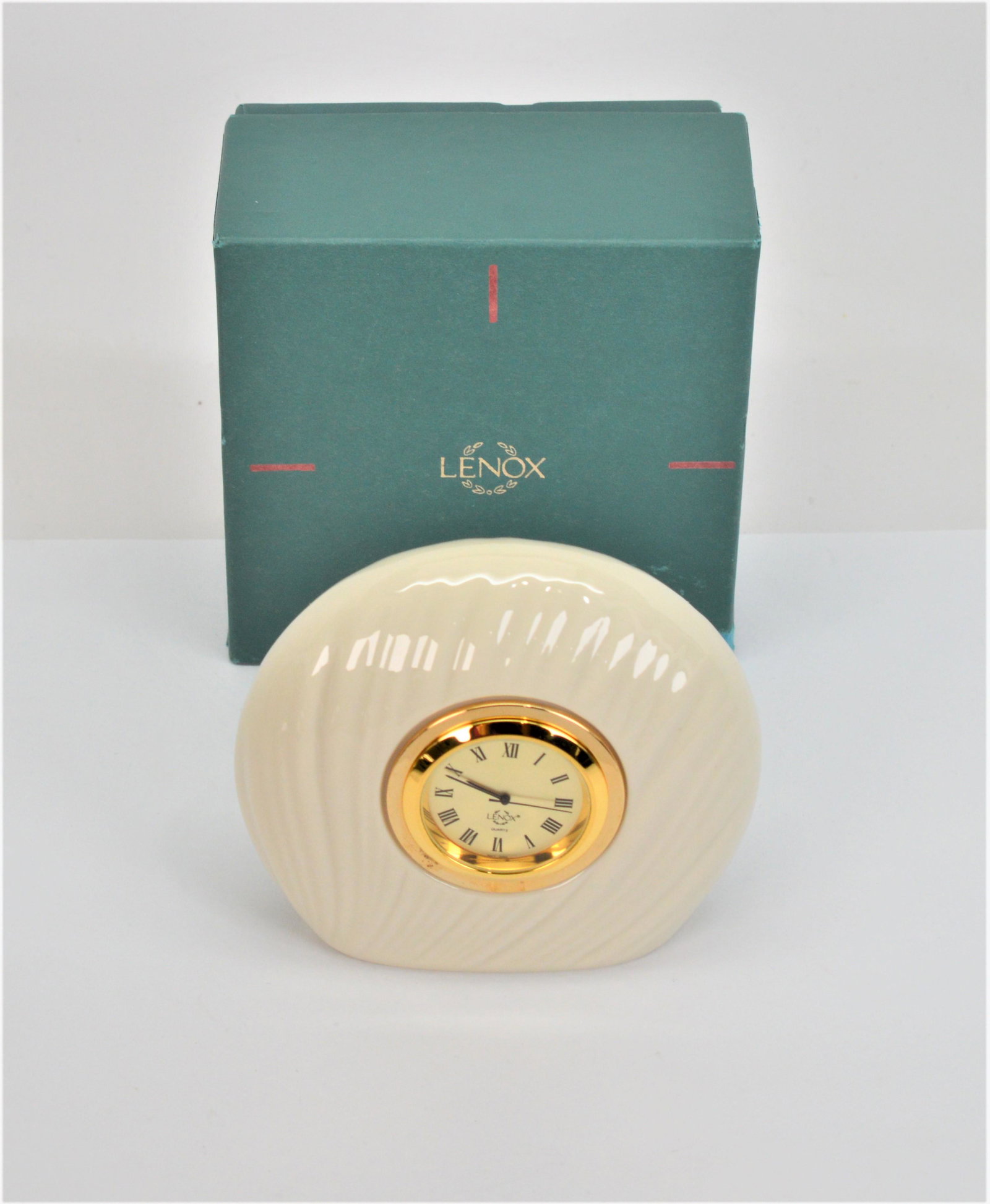 Lenox Mirage clock: Lenox Mirage Clock is 3.5 x 4 and will look pretty wherever you place it. Needs battery. -NB