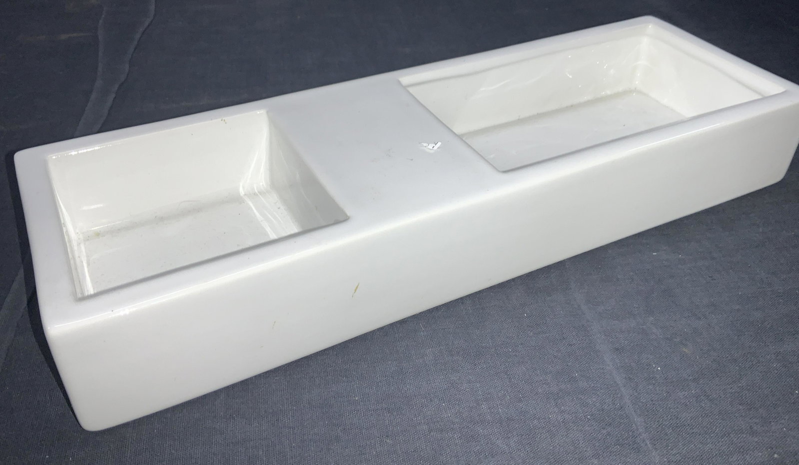 BOSA White Ceramic Rectangular Ashtray: Marked BOSA, on underside. White ceramic ashtray with two compartments. Approximately 1.75 inches tall and 12 inches long. Minor wearing to ceramic surface. Ceramic ashtray, ceramics decor, surface de