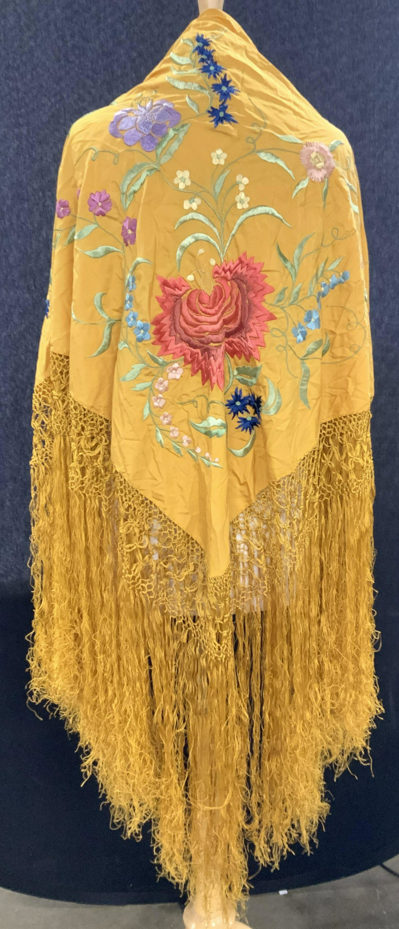 Saffron Embroidered Silk Flamenco Shawl, Spain: Silk Flamenco shawl with long tassels, embroidered with silk thread. A deep saffron color. Opposite Corner embroidery of large flower with extending flower vines, colors of coral, pastel green, navy, 