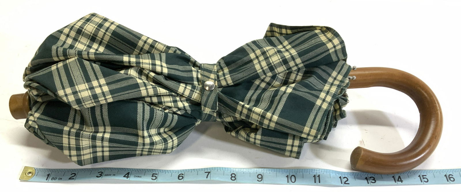 T.ANTHONY LTD Plaid J Handle Umbrella, USA: Luxury travel accessory brand T Anthony Signed Umbrella, green and cream plaid with wood J handles. Signed plaque on handle. Opens to 35.5 in. Length 24.5 in. Travel Accessory, Umbrella , signed T Ant