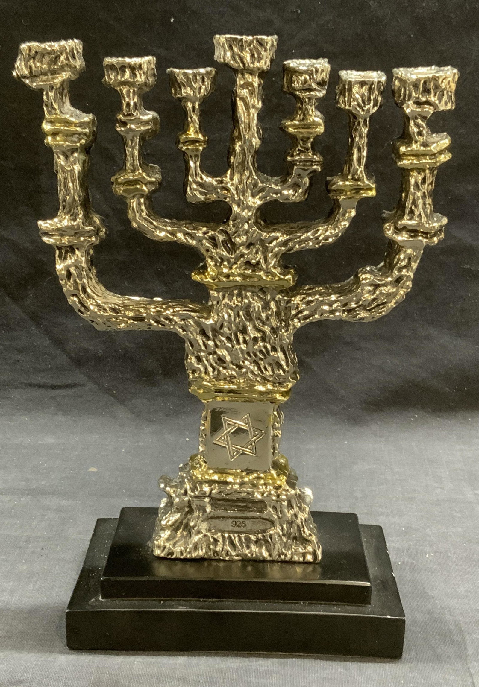 Judaica Craftsman Sterling Silver Clad Menorah: Sterling silver clad menorah on black base. Marked Craftsman 925 SC. Marked 925 on base of menorah. Measures approx. 6.25 x 3.25 x 9.5 inches. In good condition. Piece has weight. Total weight 1018.8 