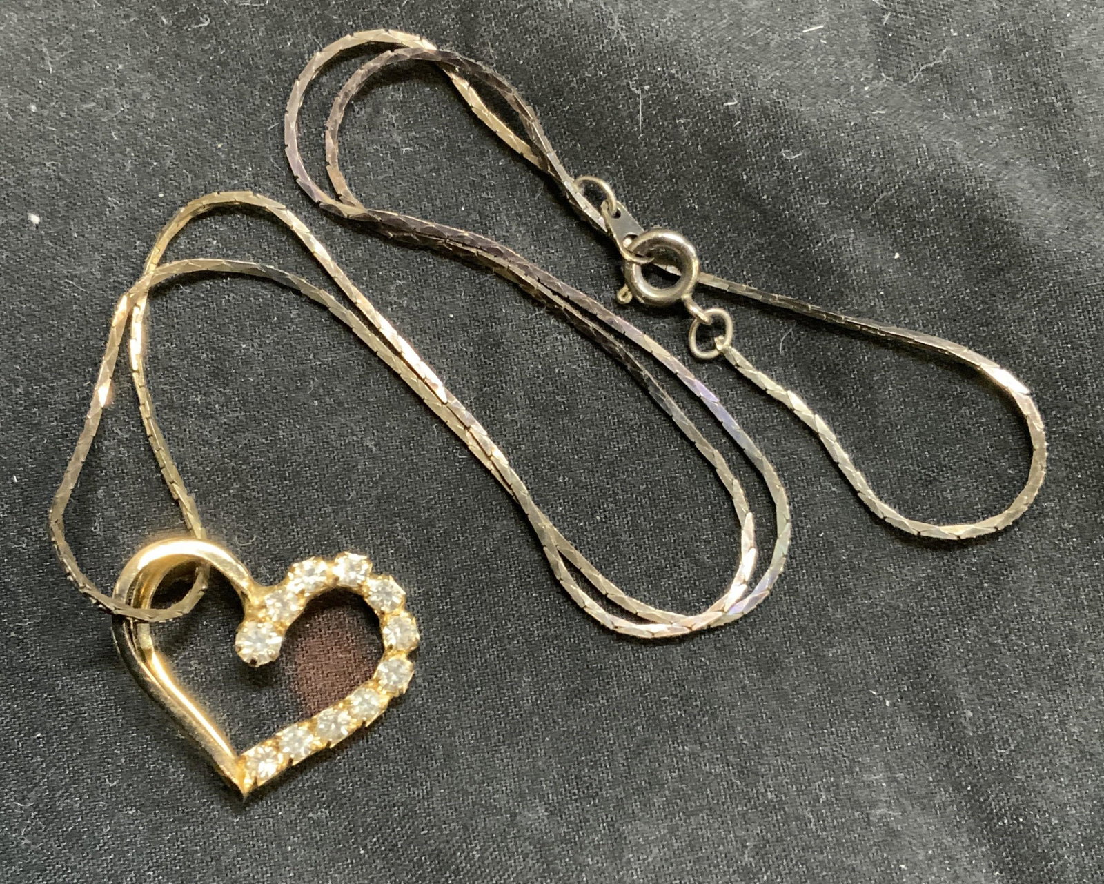 Chain necklace with Gold Tone Heart Pendant: Snake chain necklace with gold tone heart pendant and crystal decoration. Measures approx. 17.5 inches long. Pendant measures approx. 1 x .75 inches. Surface wear consistent with exposure. Estate jewe
