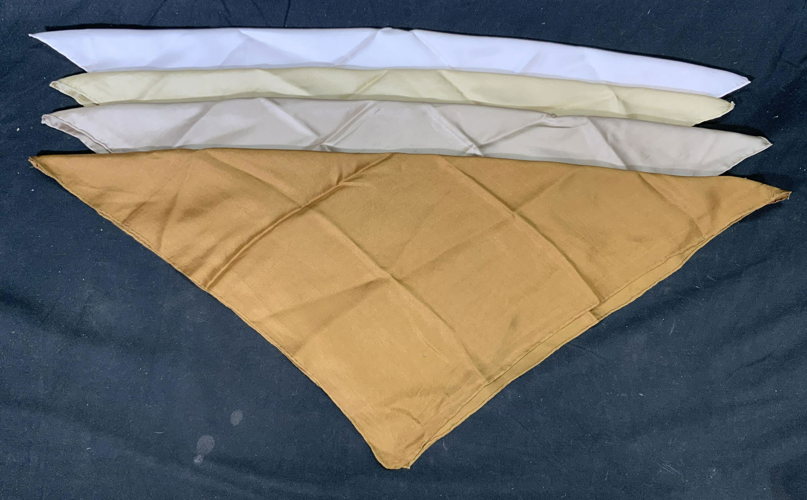 Lot 4 Vintage Pink & Beige Silk Bandanas: 4 vintage silk bandanas in hues of pink and beige. All bandanas have hand rolled hems. All bandanas have some blemishes to fabric, significantly soiled. Measures vary, approx. 18.5 x 18.5 inches. Ladi