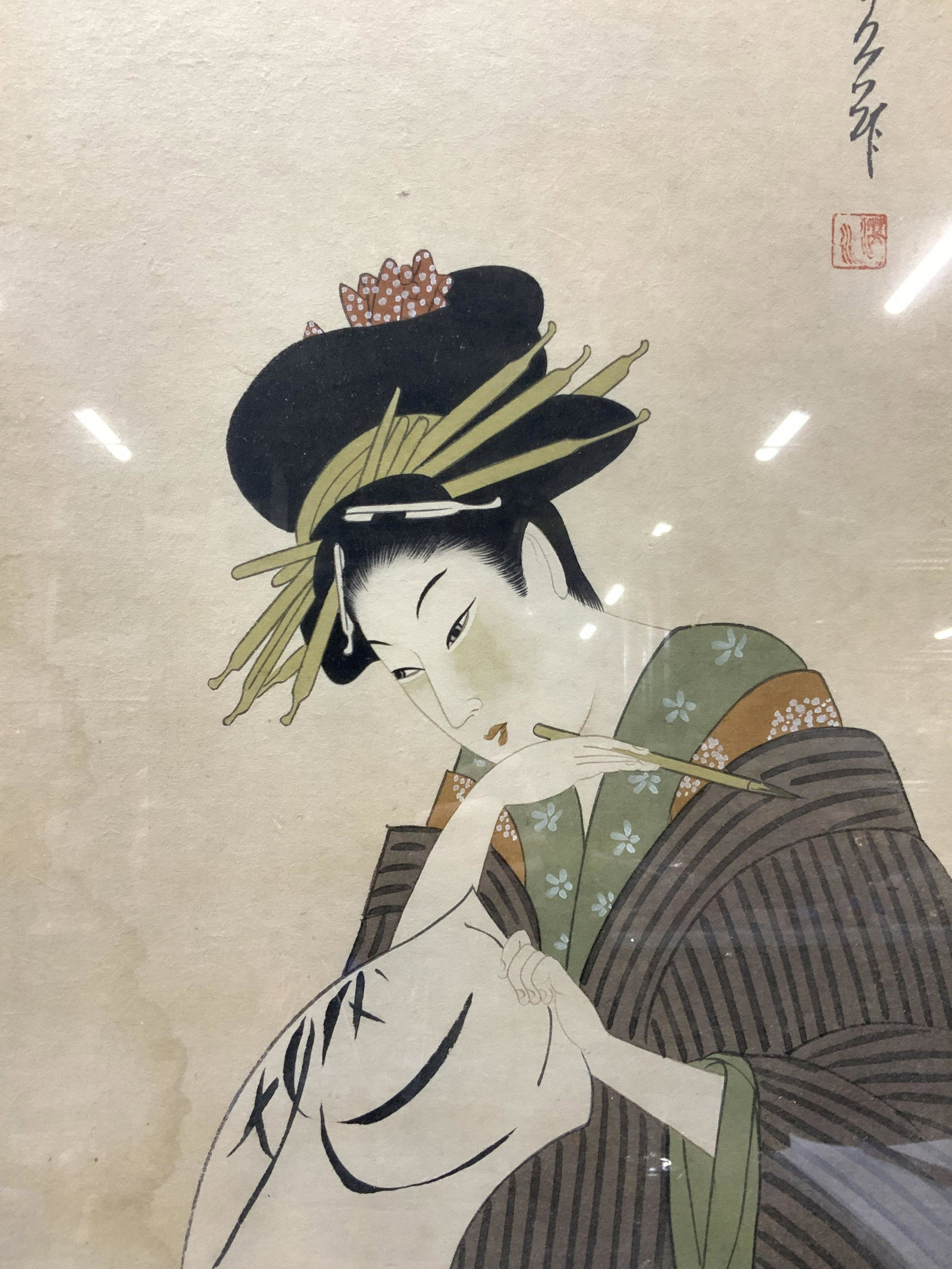 Signed and Stamped Asian Woman Ink On Paper: Marked on upper right corner in Japanese characters and with signature stamps, Subject depicts a Japanese woman in traditional hair and kimono holding a calligraphy brush in her hand and her paper in 