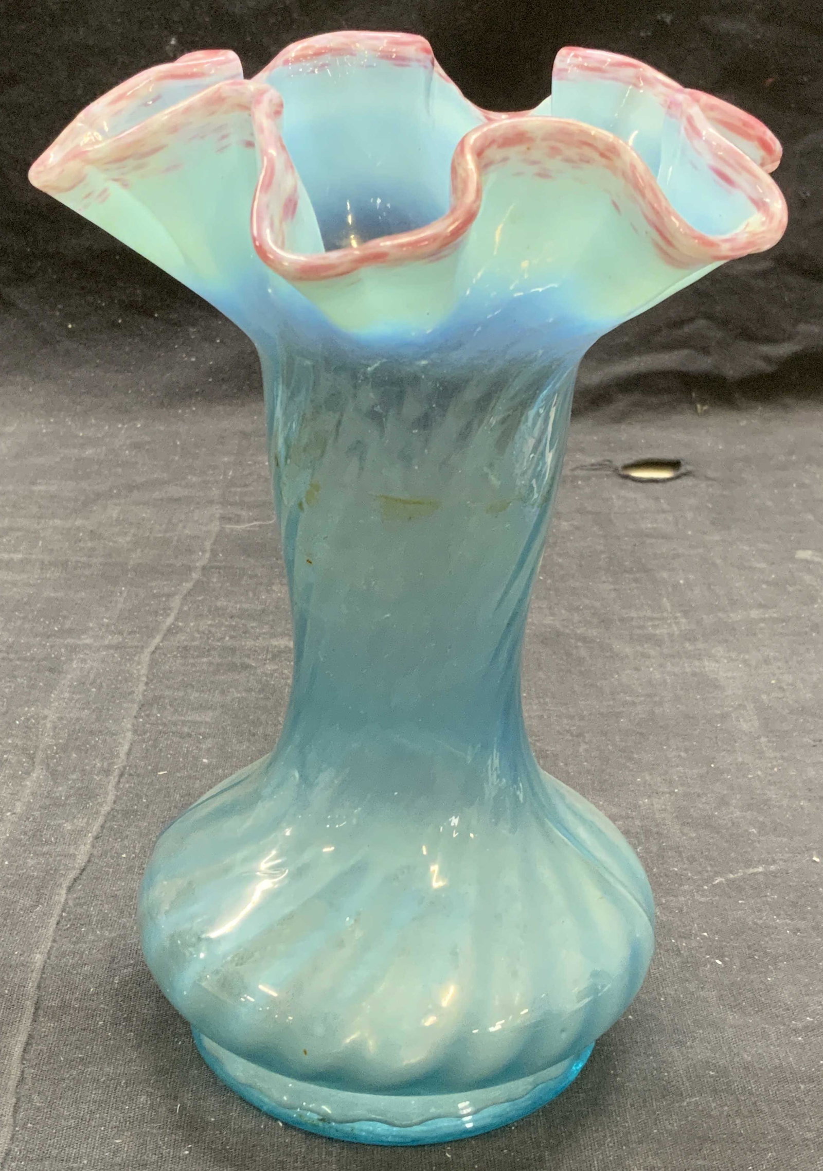 Blue Handkerchief Art Glass Vase: Blue toned art glass vase with handkerchief rim. Measures approx. 5.25 inches wide and 7 inches tall. Some surface wear consistent with exposure. Art glass, handkerchief glass, art glass vase, blue va