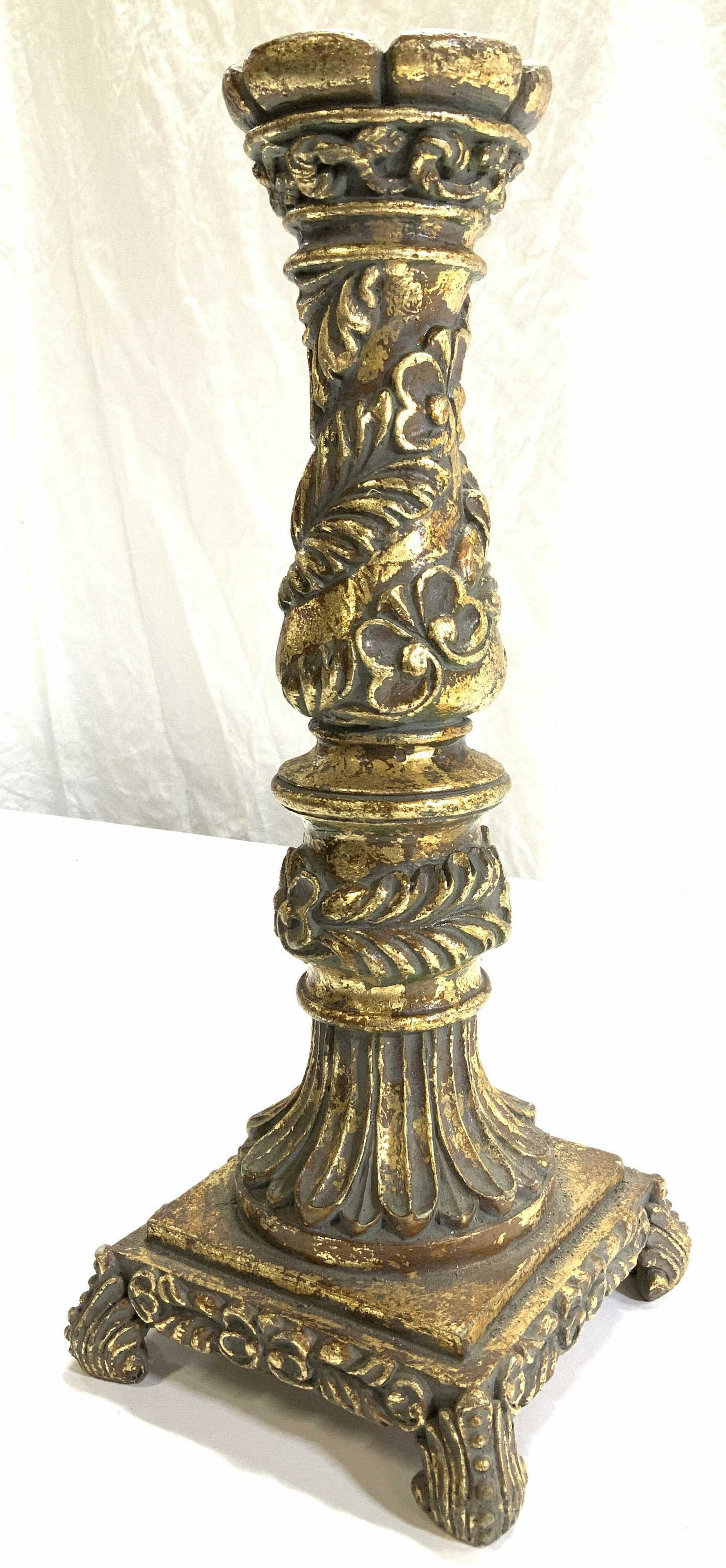 Oversized Gold Leaf Plaster Candlestick: Rococo style high relied Neoclassical candlestick covered in gold leaf. Square base with 4 acanthus feet. Measures 15.5 in ht. Base 6.25 x 6.25 in. Possibly plaster or ceramic combo. Neoclassical Gold