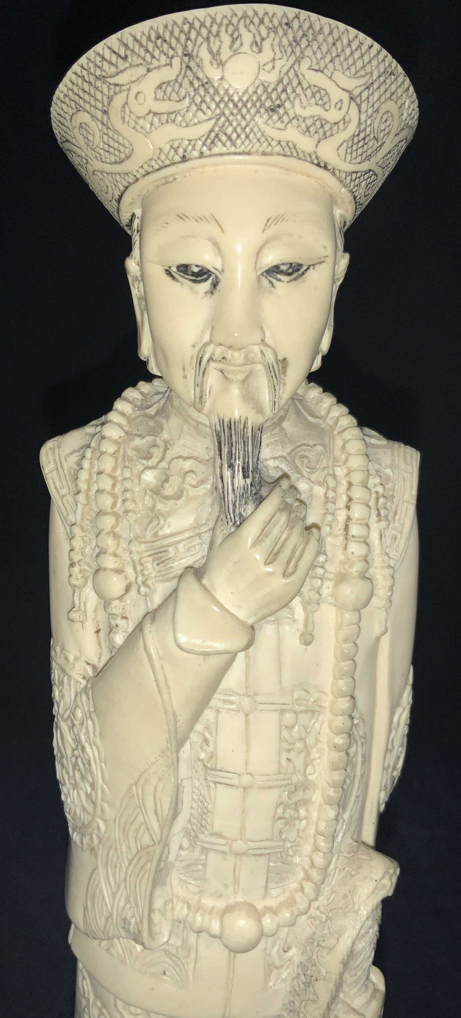 Asian Carved Bone Style Figure XL 13.5inH: Chinese resin figure, made to resemble carved bone. Figure of a man with elaborate robes with raised patterns of waves, dragons and more. Affixed to a wooden carved stand with stamp on underside. Appr