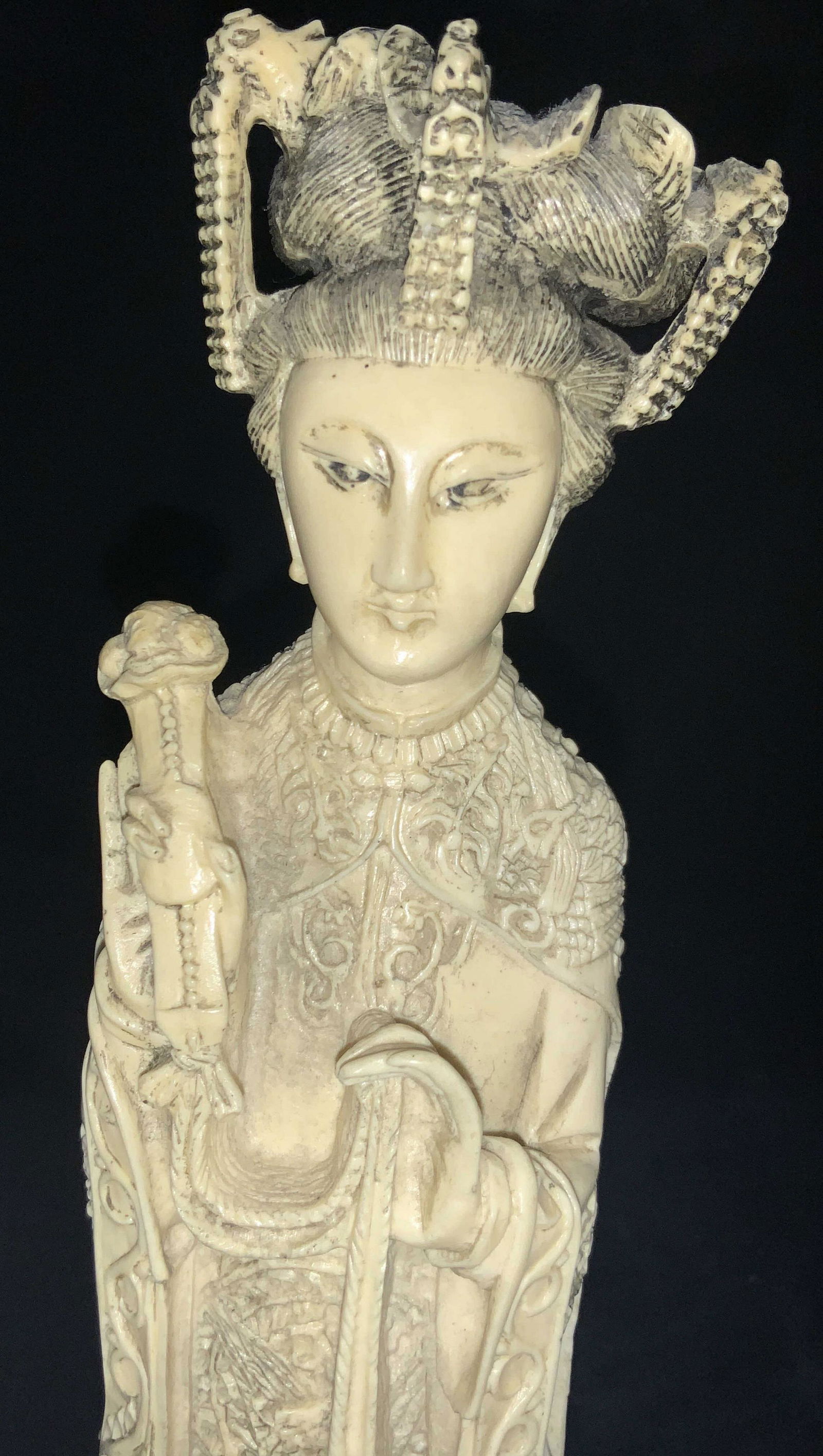 Asian Carved Bone Style Female Noble Figure 13inH: Chinese resin figure, made to resemble carved bone. Figure of a woman with elaborate headpiece and robes with raised patterns of waves, and floral patterns, holding a talisman in her hands. Affixed to