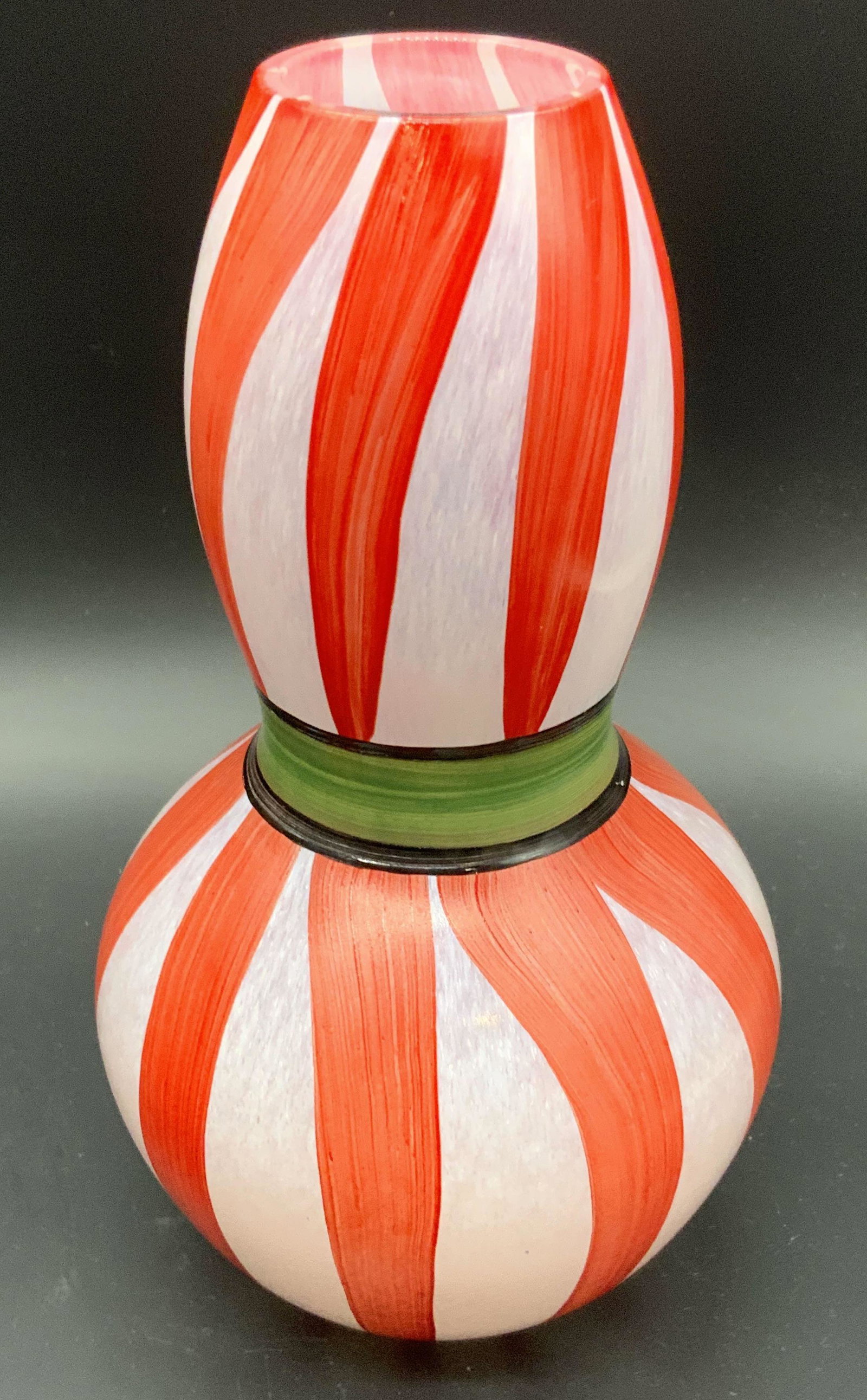 KOSTA BODA ULRIKA HYMAN VALLIEN Striped Glass Vase: Hand Painted red and white with green and black band to the center. KOSTA BODA ULRIKA HYMAN WALLIN Striped Glass Vase. 7.5H x 4W in. Measured at widest point. Underside signed UHV / BS, KOSTA BODA. St