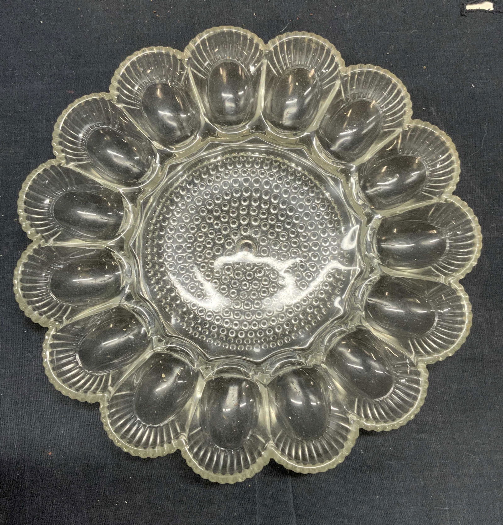 Cut Glass Deviled Egg Dish: Cut glass deviled egg dish. Measures approx. 11.25 inches diameter. Surface wear consistent with exposure. Deviled egg dish, egg dish, cut glass dish, tableware, Serveware, serving dish, table accesso