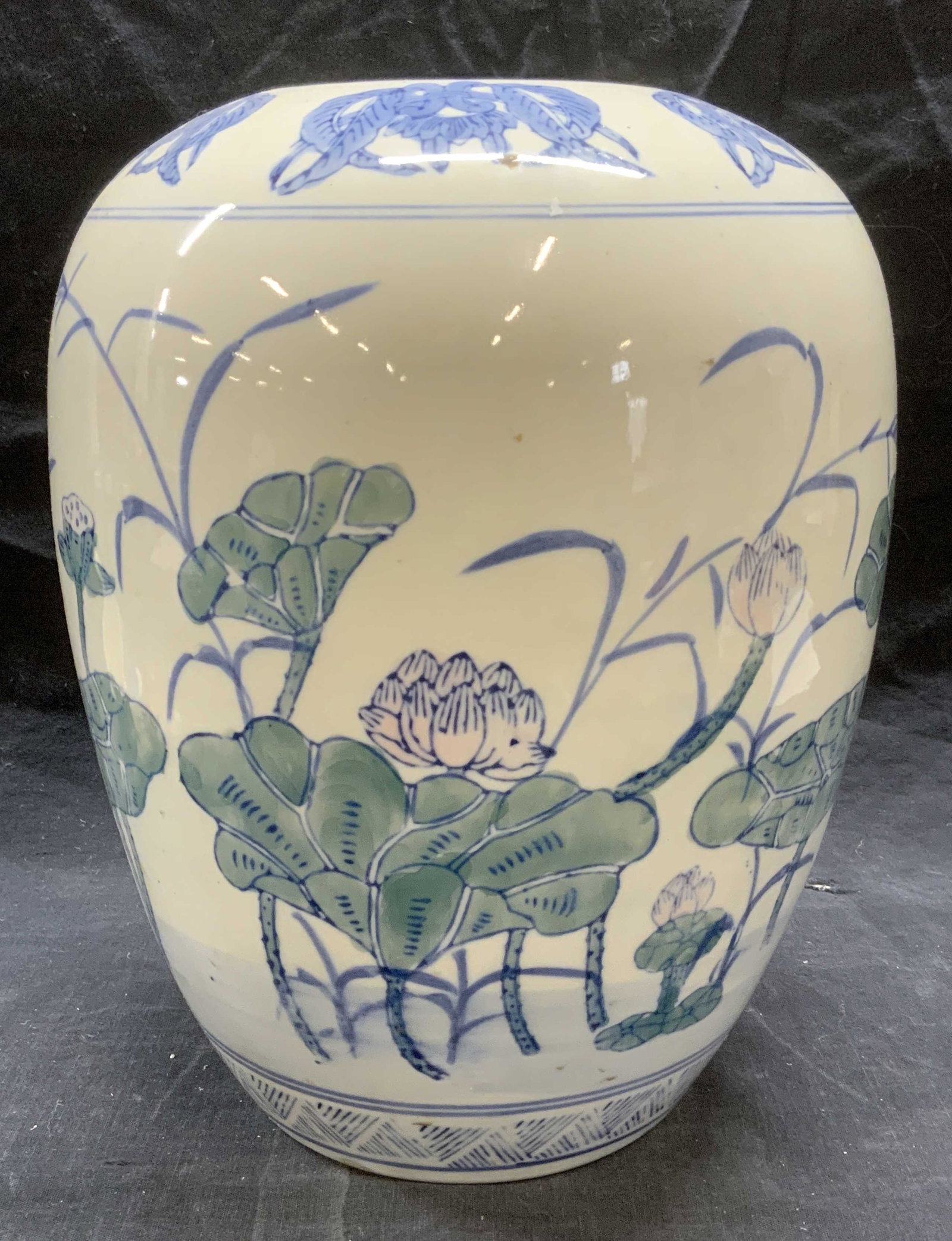 Asian Hand Painted Porcelain Lotus Ginger Jar: Asian hand painted porcelain ginger jar with lotus motif. No lid. Measures approx. 8.5 inches diameter and 10.5 inches. Surface wear consistent with exposure. Asian ginger jar. Porcelain ginger jar, l