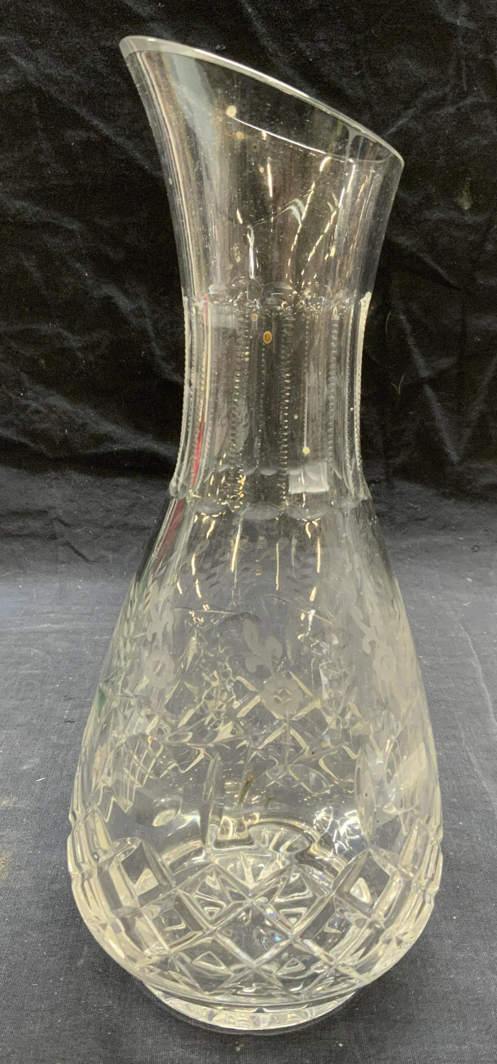 Thick Cut Floral Glass Carafe: Thick cut glass carafe with floral motif. Measures approx. 4.75 inches diameter and 11 inches tall. Some surface wear consistent with exposure. Carafe, glass carafe, kitchenware, kitchen accessories, 