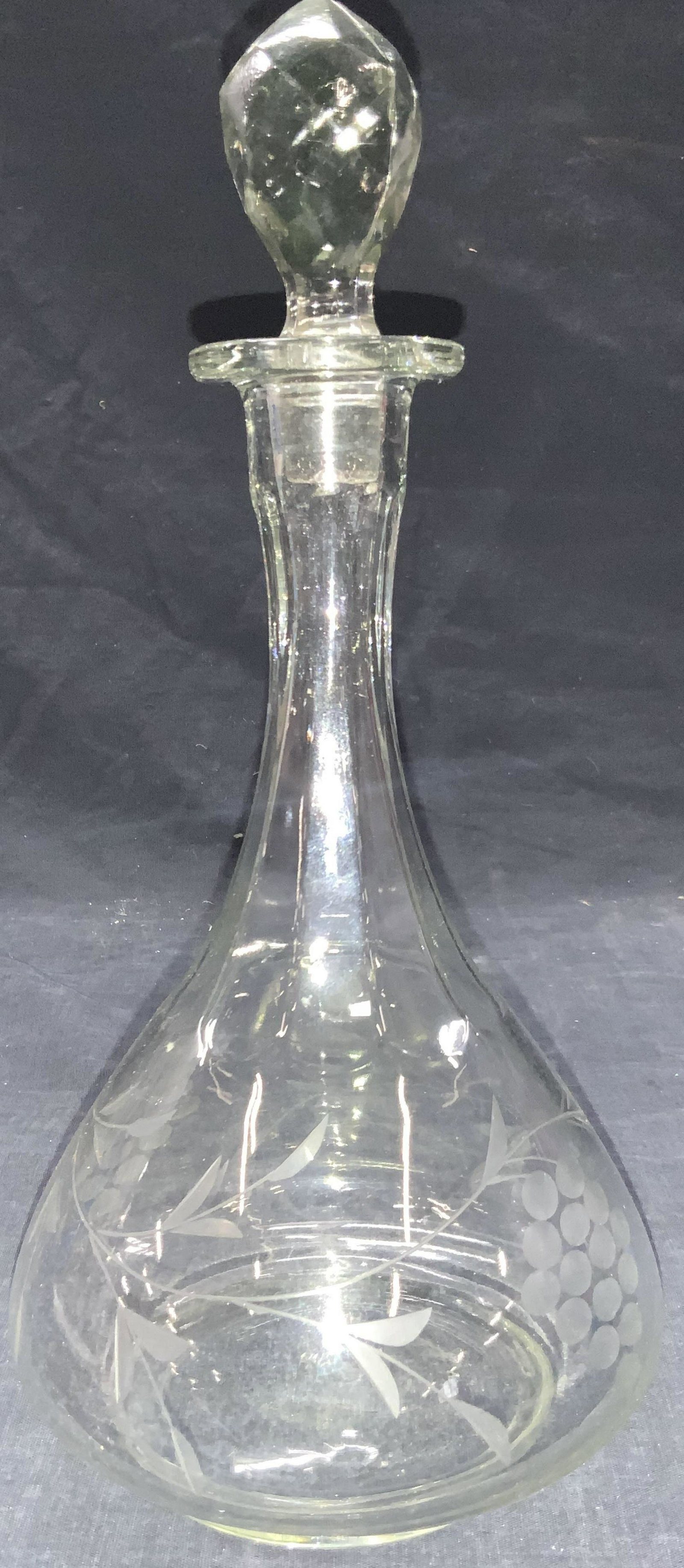 Etched Floral Molded Glass Decanter: Clear molded glass decanter with etched floral motifs on exterior. Approximately 12 inches tall Minor residue on interior of decanter. Etched decanter, glass decanter, glass Barware, Barware, whiskey 