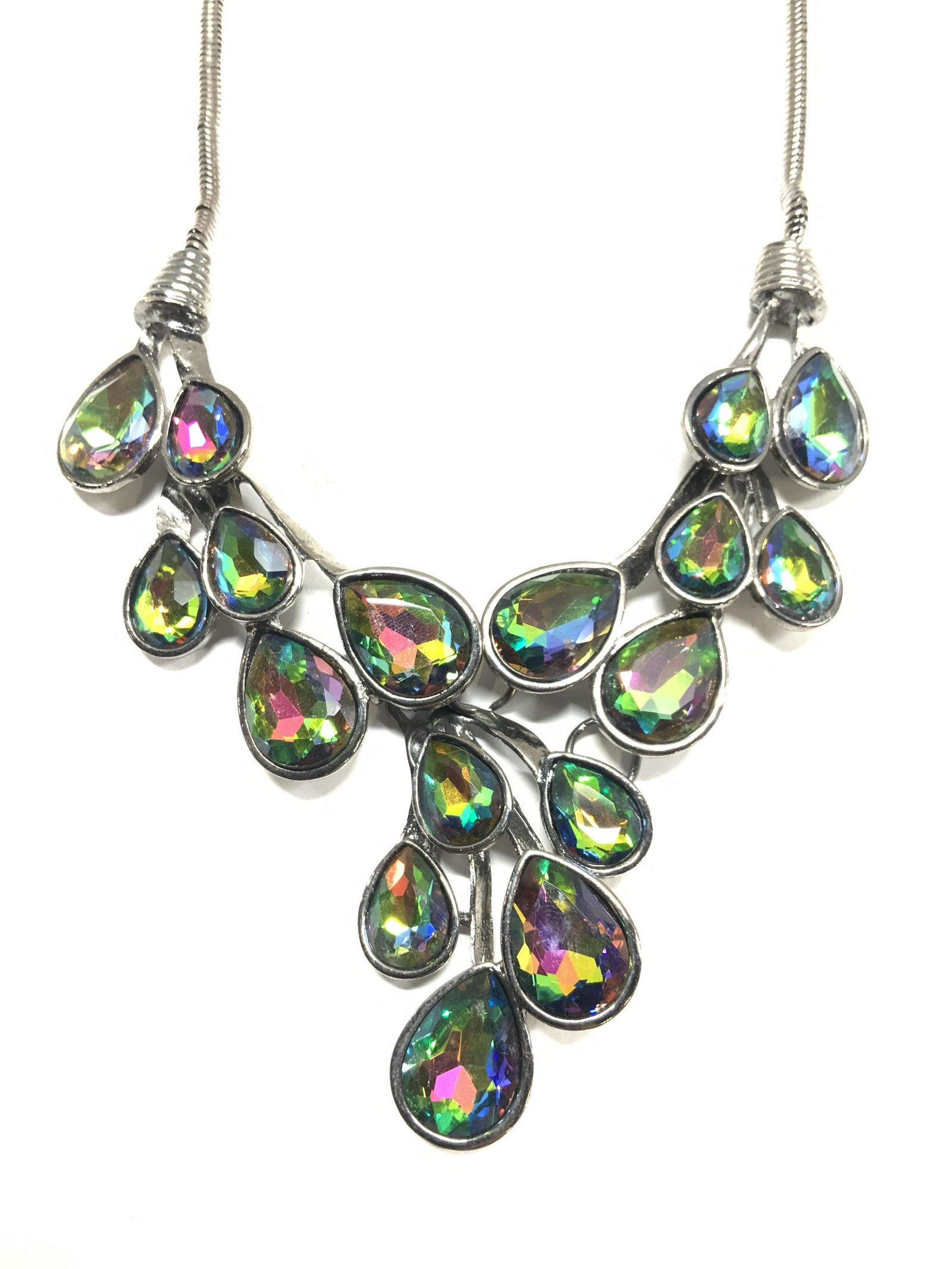 PEACOCK Tn Aurora Borealis Bib Necklace,: Tear drop shape Bib necklace with peacock toned Aurora Borealis rhinestones, gun metal snake chain. Bib measures 4 x 2.5 in. Necklace measures 13.5 x 15 in. One sections needs to be reattached and hav