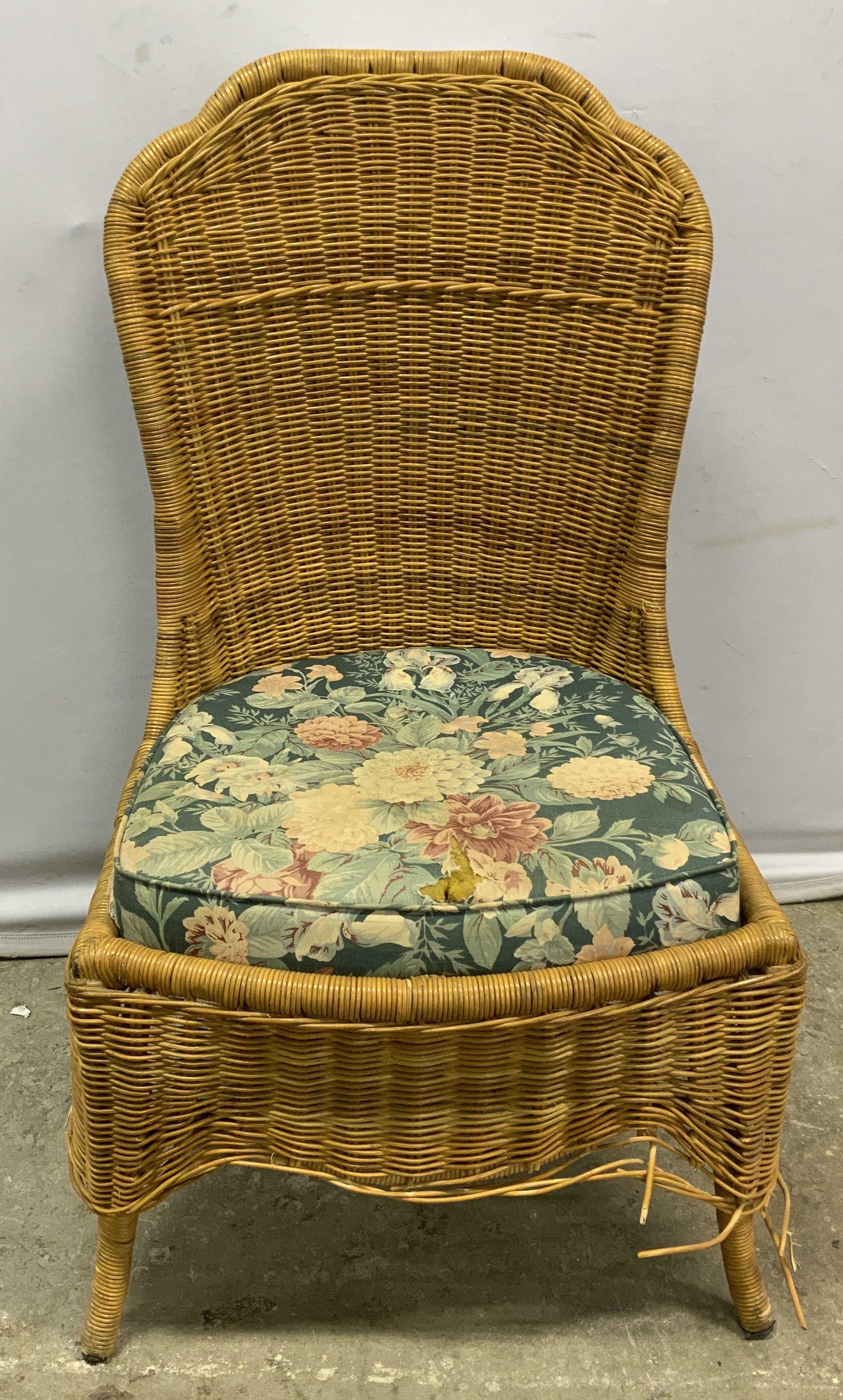 Tan Rattan Outdoor Dining Chair: Tan woven rattan outdoor dining chair with floral seat cushion. Surface wear consistent with exposure. Measures approx. 18 x 22 x 39 inches. Rattan chair, outdoor chair, outdoor dining chair, dining c