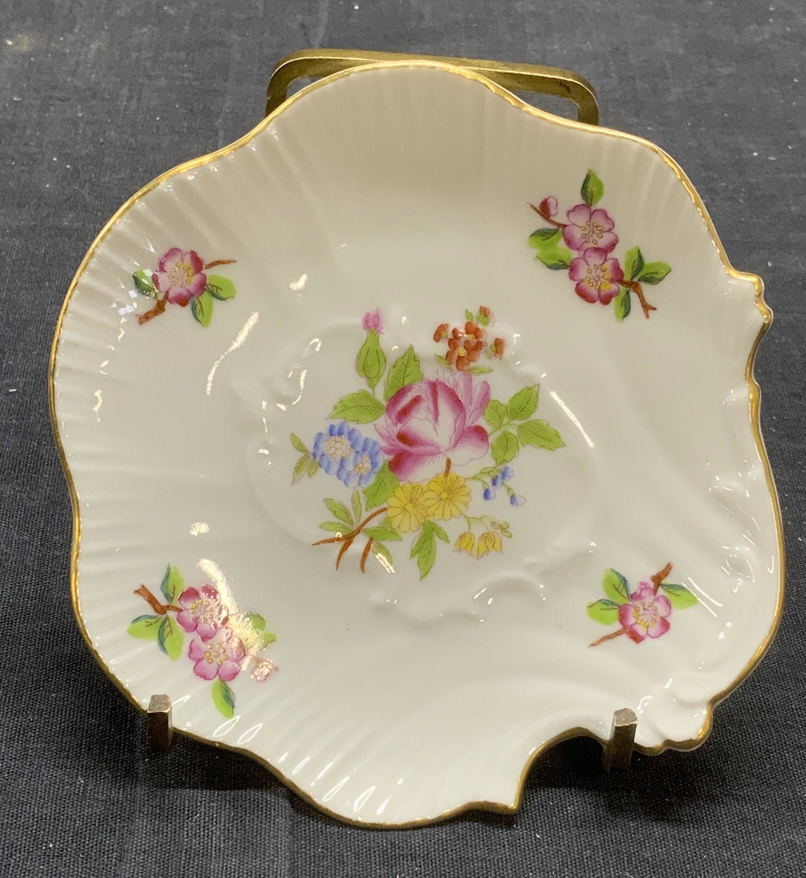 HEREND Hungary Floral Porcelain Trinket Dish: Herend Hungary hand painted porcelain trinket dish with floral motif and gilt rim. Trademarked to underside. Marked 7770. Measures approx. 4.5 inches wide. In good condition. Herend, herend hungary, h
