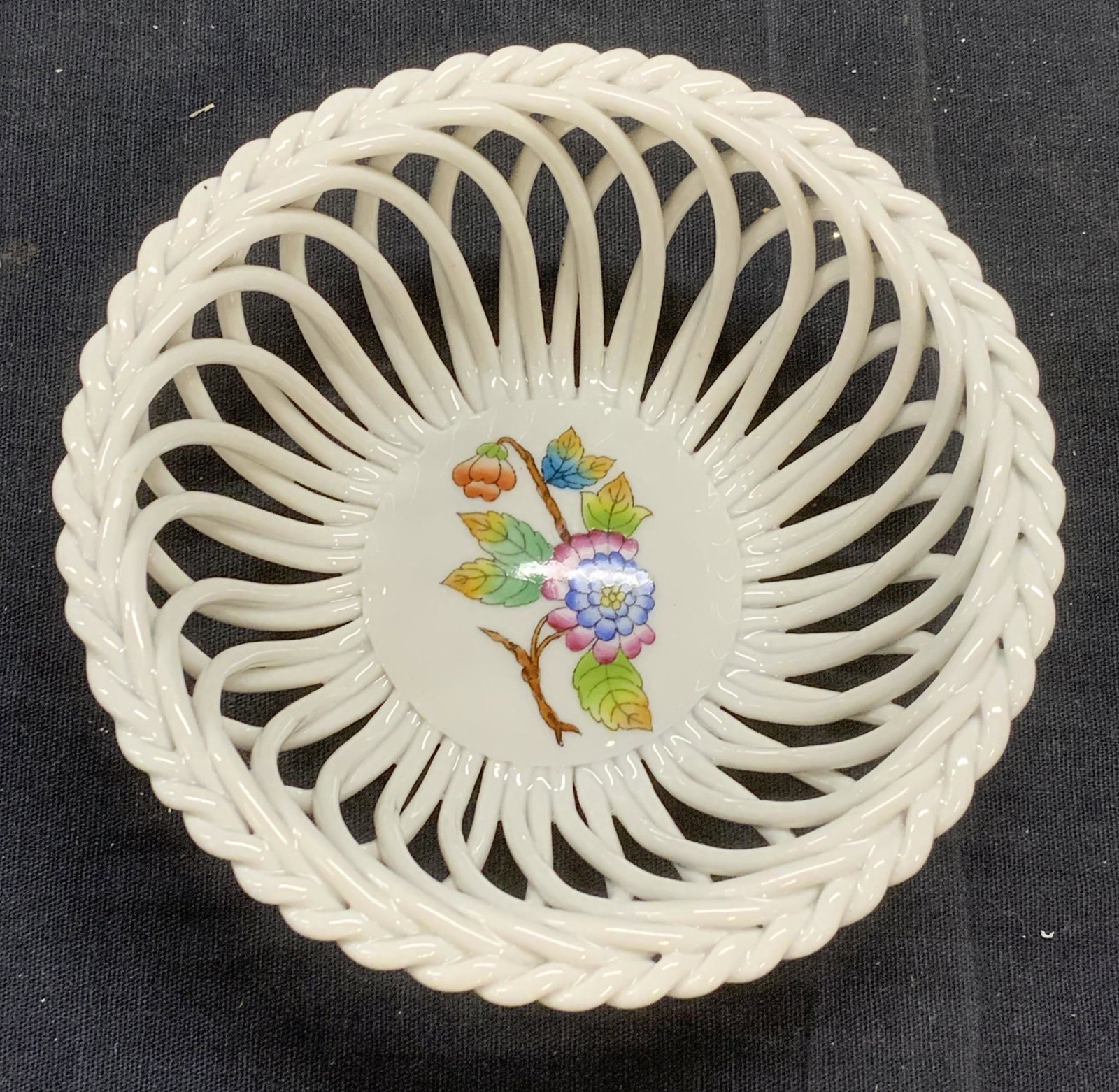 HEREND Hungary Porcelain Floral Basket: Herend Hungary porcelain basket with floral motif. Measures approx. 4 5/8 inches diameter and 1.75 inches tall. Trademarked to underside. Marked 7372 vbo. In good condition. Herend, herend hungary, He
