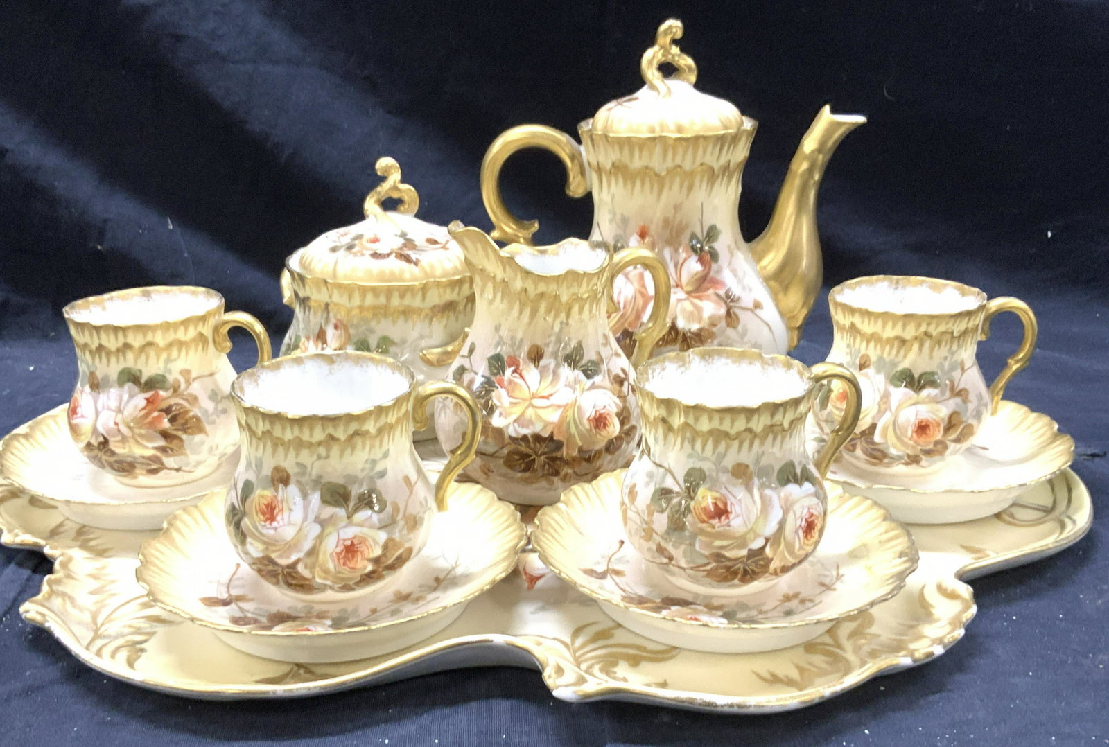 D&CoLimoges France Porcelain Tea Set 14: Hand Painted Vintage D& Co Limoges Tea set with Carry Tray. Solid Gilt on handles, finials and accented on porcelain relief. Cream toned with red to yellow roses. All porcelain hallmarked., Tray measu