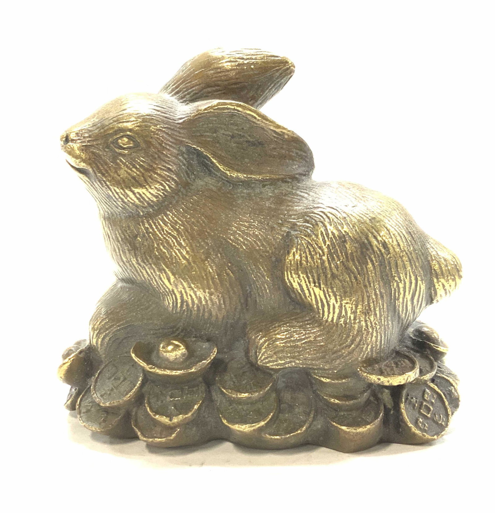 Signed Asian Brass Rabbit Figural: Signed brass rabbit sitting on Asian coins. Signed on underside with Chinese characters, measures 4 x 2 x 3.5 in. L x W x Ht Rabbit figural, Asian Brass Rabbit, Chinese Rabbit Figural, Chinese Year of