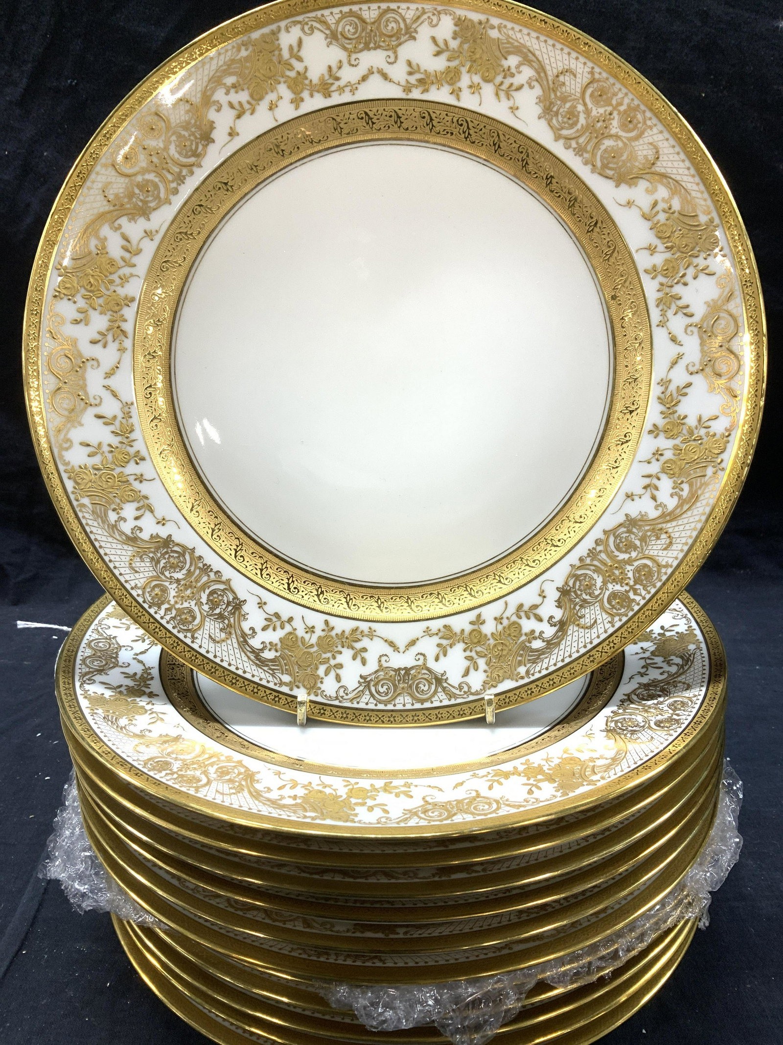 Set 12 C&A Depose Limoges Gilt Porc Plates, France: Luxury set of C. Ahrenfeldt gild plate of bright white porcelain., scroll pattern in relief, impressed solid gilt bordering. Plates measure 10.25 in. General wear and imperfections including scratches