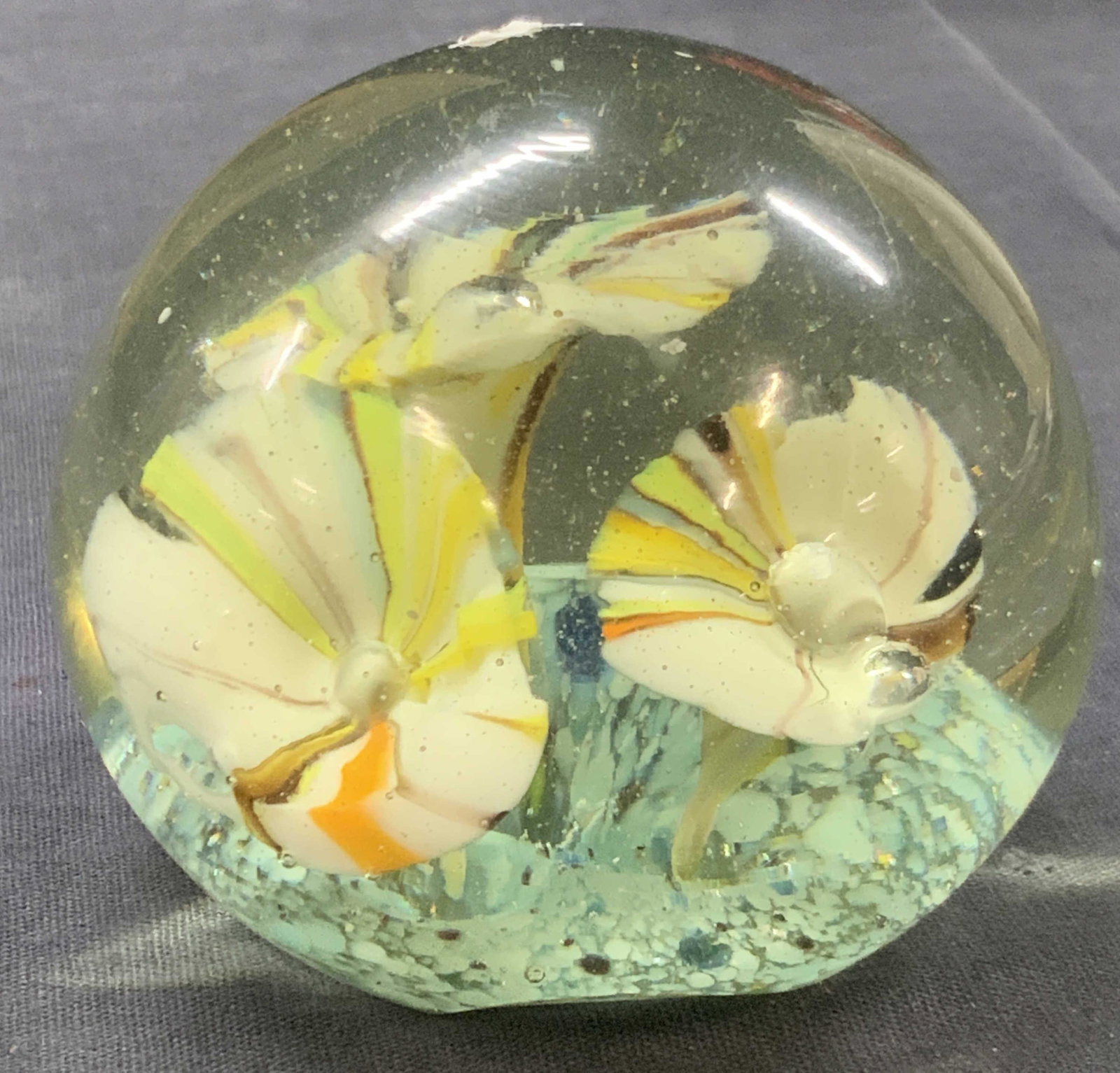 Hand Blown Floral Art Glass Paperweight: Hand blown art Glass paperweight with floral motifs on interior of glass in tones of white with streaks of colors Approximately 3 inches tall and 3 inch diameter. Minor wearing to glass. Art glass pap