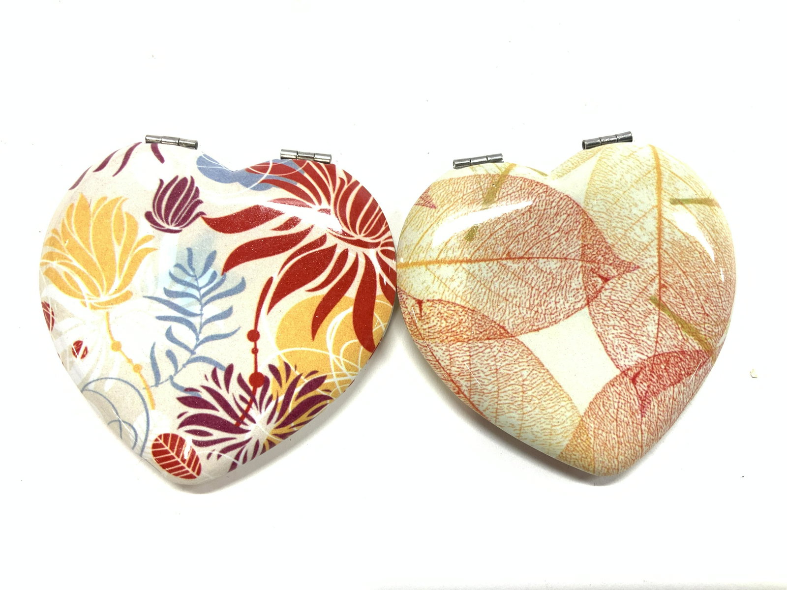 Lot 5 Enamel Compact Mirrors, NIP: 5 new compact mirrors, each with a different enamel design. All new . 3 have a heart shape , one with leaf pattern, one seashell design, and a stencil floral design. 3 x 2.5 in. Round compact with a t