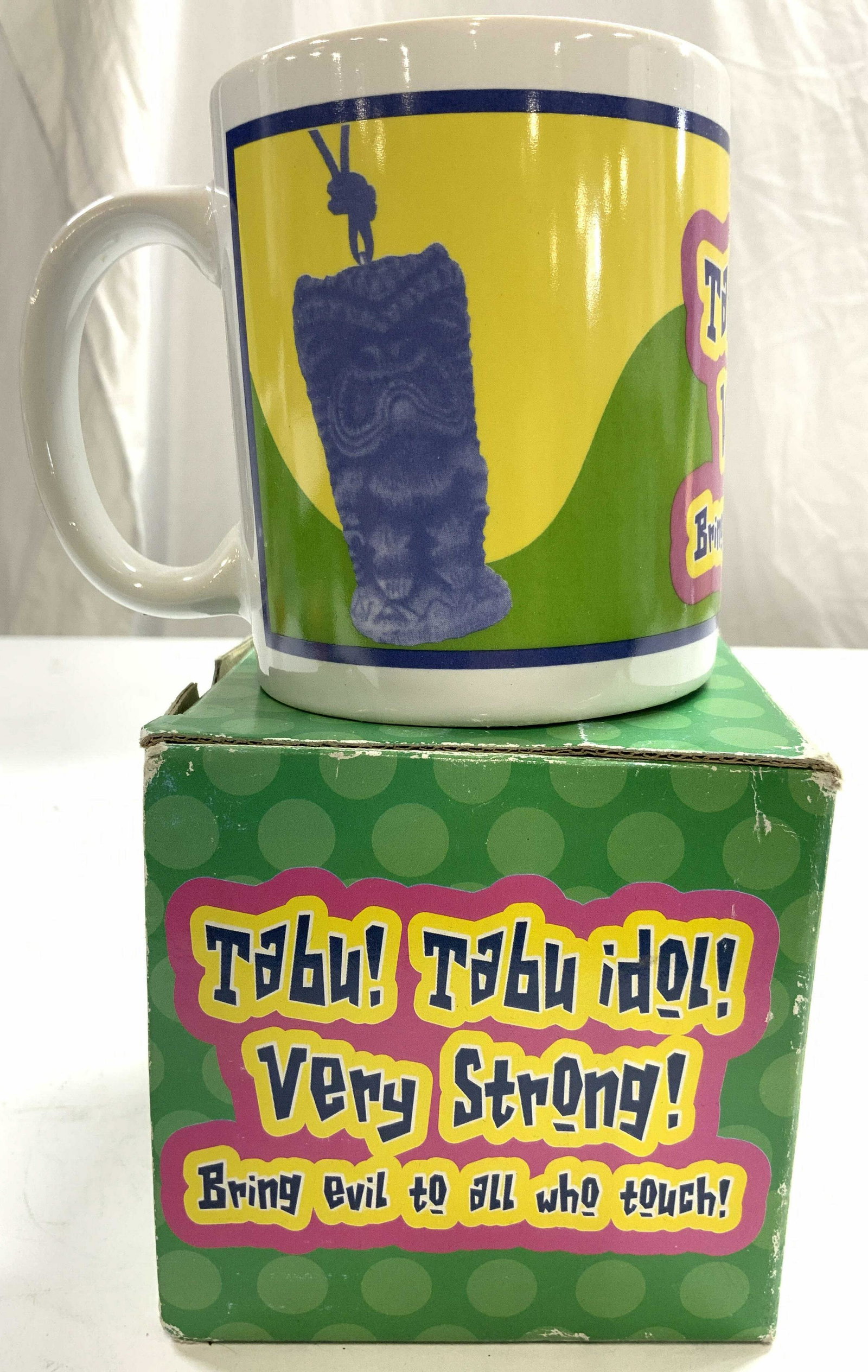 THE BRADY BUNCH Vntg Porcelain Mug In Box: Underside reads THE BRADY BUNCH ANDREWS MCMEEL PUBLISHING. Mug is porcelain and includes box. Mug reads TABU TABU IDOL VERY STRONG BRING EVIL TO ALL WHO TOUCH. Mug measures approx 3.75 inches tall 3.2