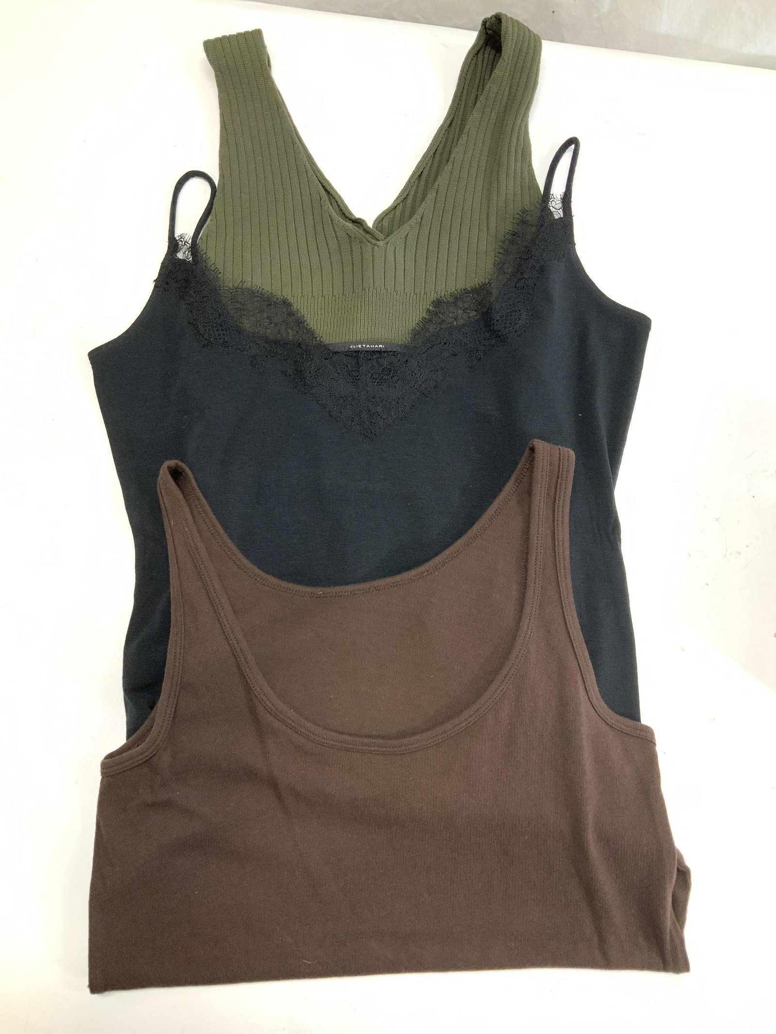 Grp 3 Tank Tops, Elie Tahari, Bink USA: Tank tops and tank top sweater, Sizes Medium and Small. designer Labels Elie Tahari and Bink USA. Cotton or nylon. Chocolate brown scoop neck, black with lace, olive green sweater tank top. Light wear