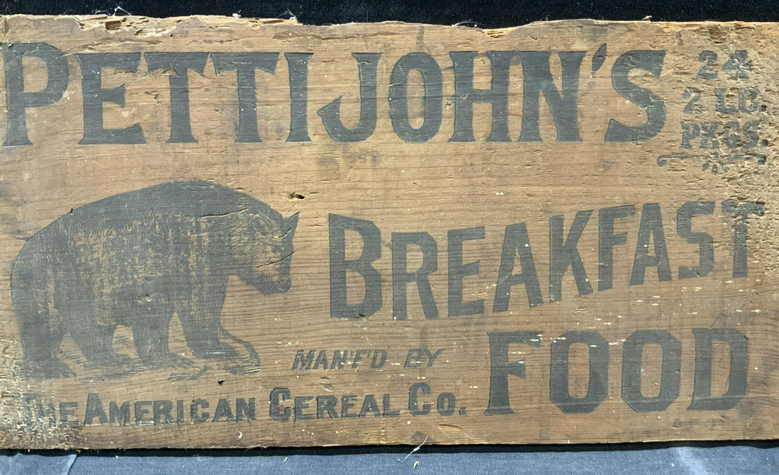 Petti John Breakfast Food Wooden Sign: Wooden sign that reads Petti Johns Breakfast Food, Manfd by The American Cereal Co. with an image of a bear in the upper left corner, Approximately 9.25 x 18 inches. Evident wearing to edges and lette